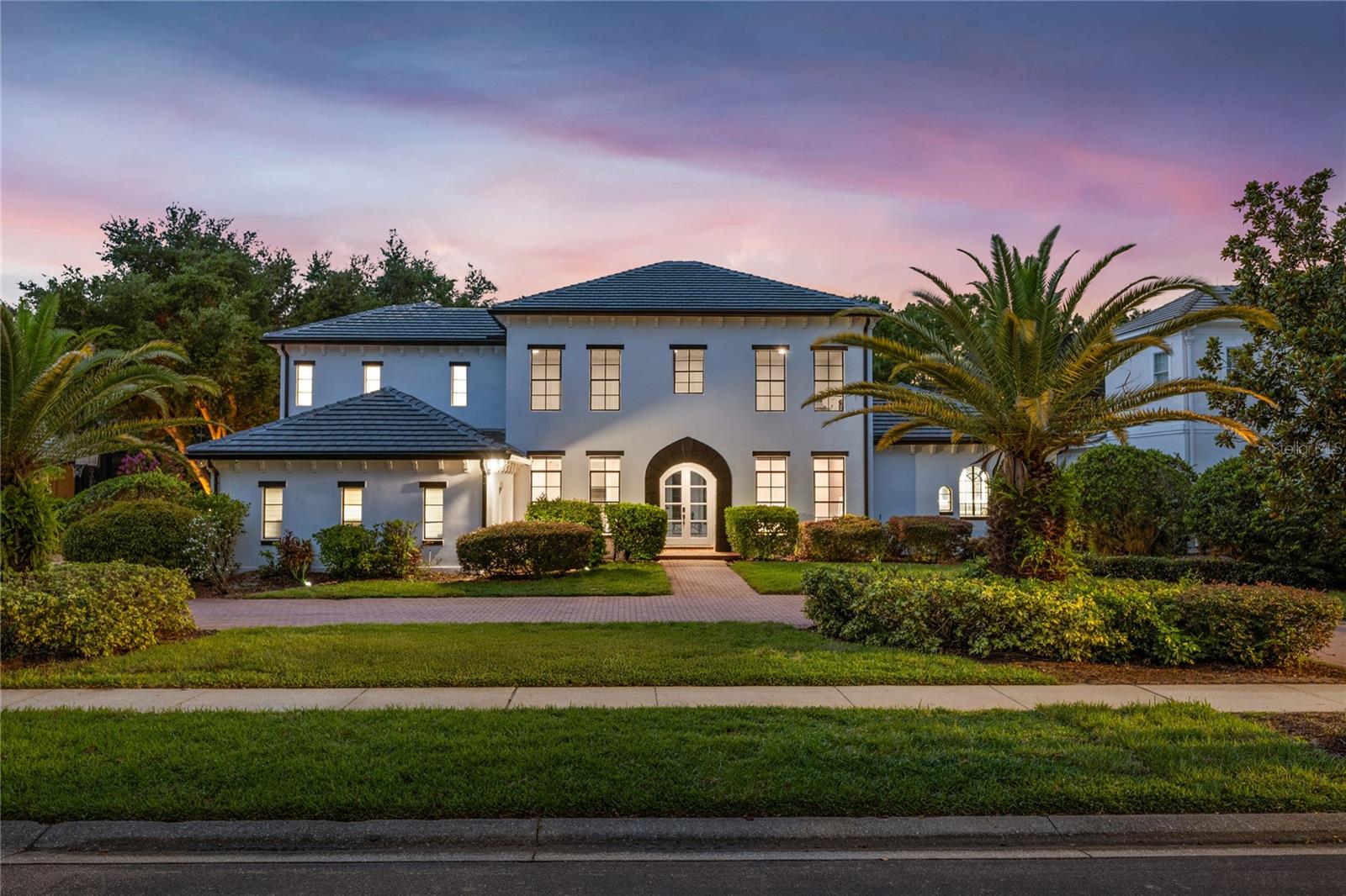 Introducing a rare opportunity to own a truly exceptional residence in the guard-gated enclave of Turtle Creek, one of Orlando’s most coveted luxury communities. This breathtaking estate has been fully remodeled in 2024 and also features a brand new tile roof and fully resurfaced pool. Boasting over 5,800 square feet of meticulously curated living space, 5 spacious bedrooms, 5.5 designer bathrooms, and direct access to the famed Butler Chain of Lakes. Step through the stately double doors and into a grand foyer where the interior unfolds with two-story ceilings, expansive living spaces, and sleek porcelain tile flooring that flows seamlessly throughout the entire home. The heart of the home is a show-stopping chef’s kitchen designed to impress. Outfitted with custom cabinetry, quartz countertops, high-end Thermador appliances, and an oversized island with waterfall edges, it is truly the chef enthusiast's dream. The kitchen flows effortlessly into an expansive family room featuring a stylish electric fireplace, a full wet bar with a wine fridge, and tons of windows with views of the canal and backyard. The first-floor primary suite is a true private retreat. Generously sized and elegantly appointed, it features a sitting area with water views, a large walk-in closet, and a spa-inspired bathroom complete with a freestanding soaking tub, oversized walk-in shower, and dual vanities adorned with designer finishes. Upstairs, additional guest bedrooms are well-appointed, each offering ample space, natural light, and beautifully renovated bathrooms with modern touches. Additional upstairs amenities include a versatile living area, a dedicated office, and a gym. Step outside into your own private resort. The newly resurfaced pool is framed by a spacious screened-in patio and covered lanai, ideal for lounging, dining, and entertaining. Beyond the pool lies the crown jewel of the property: your private boat dock nestled along a tranquil canal with direct access to the Butler Chain of Lakes. As a part of the Turtle Creek community, residents enjoy 24-hour guard gated security, tennis courts, a playground, and a serene setting just minutes from renowned dining on Restaurant Row, world-class shopping, championship golf courses, and Orlando’s most elite private schools. Don’t miss the opportunity to make this amazing fully remodeled home yours.