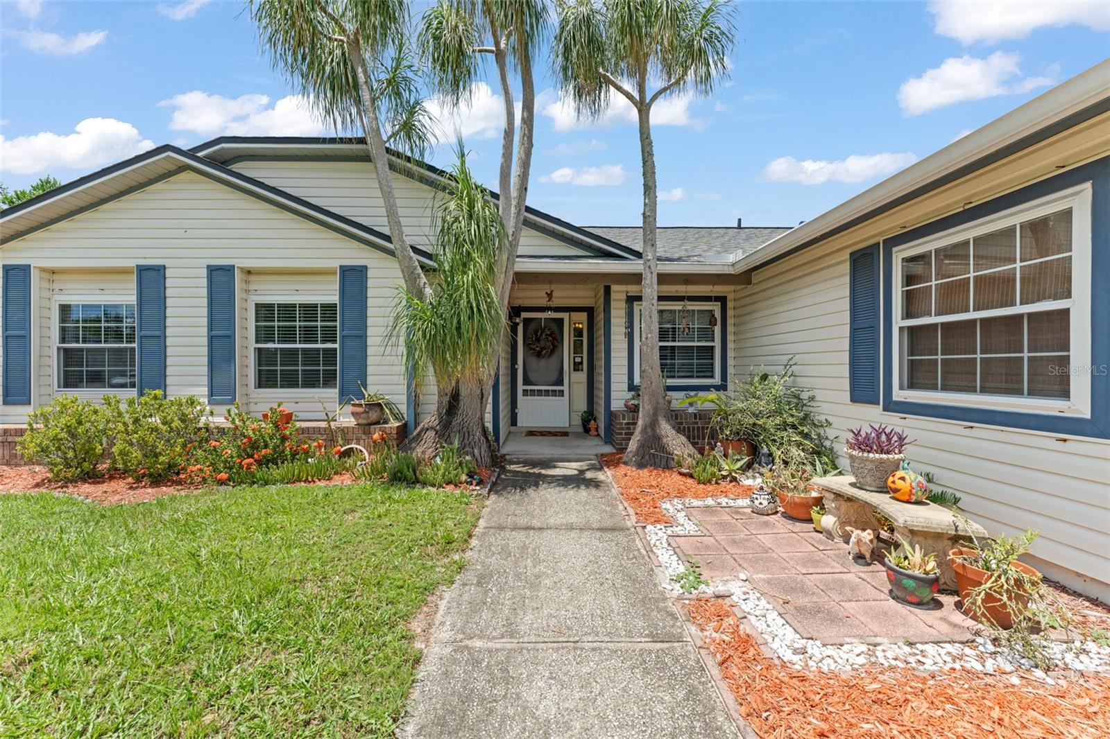 **This house comes with a REDUCED RATE through the seller's preferred lender. This is a lender-paid rate buydown that reduces the buyer's interest rate and monthly payment.** This lovingly cared-for 3-bedroom, 2-bathroom single-family home offers nearly 1,400 sq ft of inviting living space, a 2-car garage, and a backyard that’s perfect for gathering, relaxing, and enjoying Florida living. From the moment you arrive, you're greeted by a beautifully manicured front yard with two welcoming trees flanking the walkway that leads you to the front door. Inside, the home opens up with a warm and bright layout—to your left, a formal dining room with a large front-facing window perfect for sharing meals and laughter. To your right, a bright and functional kitchen features white cabinetry, granite countertops, stainless steel appliances, and a serving window that connects seamlessly with the living room. There's also direct access to the garage—making unloading groceries a breeze. The home features tile flooring in the living areas and wood floors in the bedrooms, enhancing the clean, cohesive feel. Step into the cozy living room, where vaulted ceilings create a sense of space and openness. A glass sliding door invites you out to the screened-in porch and backyard, blending indoor and outdoor living beautifully. The split bedroom floor plan ensures privacy and comfort for everyone. The primary suite is your peaceful retreat, with a double-wide built-in closet and an ensuite bathroom featuring an oversized corner bathtub, a tub/shower combo, and an extra-long vanity with a quartz countertop. On the opposite side of the home, you'll find two additional bedrooms with built-in closets, and a full guest bathroom—tile-lined and equipped with a tub/shower combo—just steps away. Step outside to enjoy your own screened-in porch, complete with ceiling fan and ample space for relaxing or entertaining. Beyond lies a fully fenced backyard, perfect for play, pets, or peaceful mornings. Enjoy evenings around the built-in fire pit, host gatherings on the paved seating area, and take advantage of the shed (added in 2017) for extra storage. This home has seen thoughtful updates over the years to enhance comfort, efficiency, and style. Major upgrades include a new septic tank and drainfield (2012), complete kitchen renovation, new windows, AC system, and heating ducts (2014), master bathroom and water heater (2015), wood floors (2016), hall bathroom remodel, tile flooring, updated plumbing, custom closet organizers in all bedrooms, and a new roof with 25-year shingles (2018). This home isn't just a place to live—it’s a place to grow, gather, and create your next chapter. Tucked away in a quiet, established community, yet conveniently located near shopping, dining, and major roadways, 504 Hager Dr offers the perfect balance of peace and practicality. Come experience the warmth and charm for yourself—this is the kind of home that just feels right.