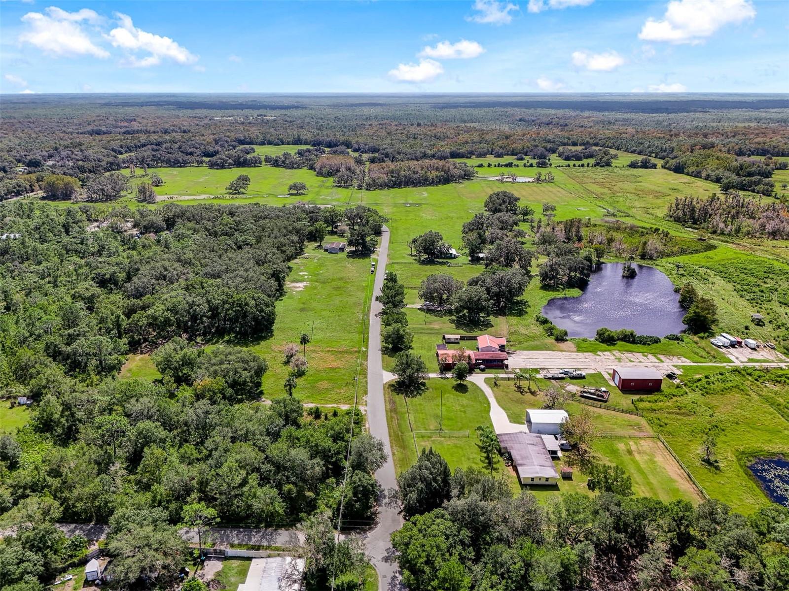 Over 100 acres in the heart of East Orlando and currently the last operating cattle ranch in Orange County! The possibilities for this property are endless with the working ranch operating on 20 parcels combined with the opportunity to live in or rent out multiple homes. Zoned A-2 and R-1 these parcels allow you to live outside the constraints of an HOA while still being close to every convenience with a variety of uses. Sitting just South of SR 50 you are only minutes away from shopping and dining with easy access to Downtown Orlando, Waterford Lakes, or head East to enjoy local beaches. This sprawling acreage features 5 homes, 2 of which are currently leased out, 2 barns and 2 lakes! Also noteworthy and a fun fact: there is a Chuck working on property that has been with the farm for 40+ years and the beautiful Victorian home is 150 years old. Approximately 50 full size cows call this farm home with another 8 to 10 calves (cows can be sold at market “on the hoof price” based on going rate at the time of sale, otherwise they do not convey). Floor plans, Matterport and additional info available. Call today to schedule a tour and explore the never ending opportunity that is 5th Street in 32833! https://vimeo.com/1022334589