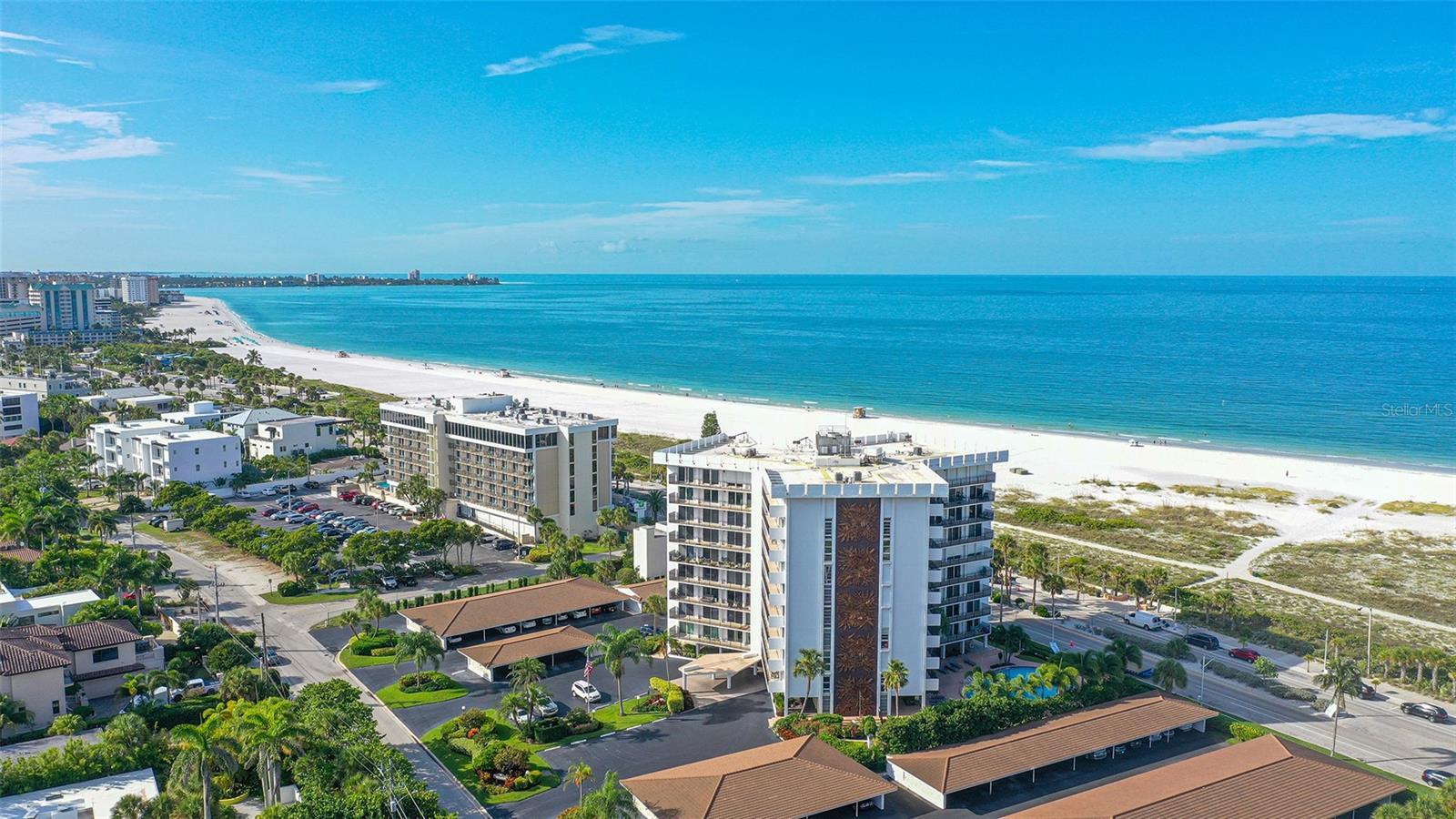 ST ARMANDS TOWERS SOUTH - This rarely available beach condo in one of the most desirable communities in Florida lets you experience the relaxed Lido Key lifestyle from a landmark location directly across from Lido Beach, and just two blocks from the renowned St Armands Circle, a premier shopping and dining destination. This 5th floor east-facing residence is being sold furnished, with a few exclusions, and offers 1,275 sq ft of interior living space in an open floor plan, with two bedrooms and two full bathrooms. Thoughtfully updated and beautifully designed, the residence has expansive sliding glass doors that lead from the living room and both bedrooms to the balcony, bringing the outdoors in and adding light, while flowing seamlessly to the outdoor living area on the private 240 sq ft balcony. Casual elegance is evident in all of the improvements throughout, with details such as fans in the living room and both bedrooms, smooth-finished walls and ceilings in a coastal palette, and oversized ceramic tile floors that make clean-up a breeze, after days spent lounging at the beach. The kitchen is open to the spacious living room and dining room, and is equipped with recessed lighting, stone counters, an undermount sink, beautiful cabinetry with plenty of storage, and stainless appliances. The primary bedroom includes an en suite bathroom and generous walk-in closet, and the additional bedroom is perfect for a home office, or an extra room for guests. There is a storage closet in the unit, and one covered carport space is also included, with a private storage locker for beach toys, and the building offers some bicycle storage for owners. Whether you’re looking for a permanent residence, or a vacation getaway, this delightful condo is the ideal Lido Key retreat. St Armands Tower South is a pet friendly building (< 25 lbs), with amenities that include a heated pool with Gulf views, community room with kitchen, library, fitness room, laundry room on each floor, and onsite management and maintenance supervisor. The property fared very well in the recent storms, as the building has been well maintained with recent renovations that include an updated lobby and fitness center, resurfaced swimming pool, newer hallways, upgraded building plumbing, and the entire exterior was freshly painted in 2022 (including the balconies and railings). Located just 3 miles from downtown, where else can you live so close to arts, culture, entertainment and a world-class beach? From the sun-kissed sands of Lido Beach to shopping at St. Armand’s Circle or experiencing the museums and performance art of Sarasota, you’ll be able to take full advantage of the good life from this iconic locale on Florida’s “Cultural Coast.” Request an appointment today.