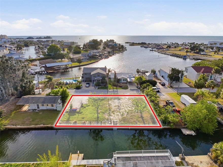 Double lot for a total of .17 acres and 100ft of water frontage. Starting you off on a clean slate, this lot is cleared and the utilities are all available on the street. Easy ride out to the gulf, this lot offers direct access. Close to the marina for other storage needs. Also there is a restaurant and bar within walking distance. Seawall. Great neighbors!! Shopping is easy to get to. Shed does not convey.