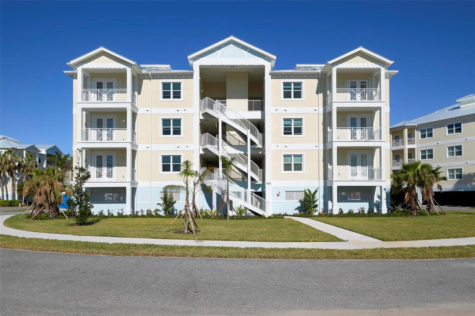 Ready to move in, this brand-new construction condominium offers stunning water views of Palma Sola Bay Club! Nestled in the heart of West Bradenton, Palma Sola Bay Club is just minutes away from the sandy beaches of the Gulf to the west and surrounded by culture, fine dining, entertainment, and golf courses to the east. The gated community spans 30 acres of protected land, featuring three stocked ponds, lush tropical landscaping, a dog park, and an observation deck with a kayak launch overlooking the bay. Inspired by Key West architecture, with two and three-bedroom floor plans. Inside, you’ll find open floor plans with large windows that flood the space with natural Florida sunshine, solid wood cabinetry, spa-inspired bathrooms, spacious closets, and much more. The two-story clubhouse at the community’s center offers a fitness center, billiards table, social room, and two kitchens perfect for entertaining. Outdoor amenities include a heated pool with an expanded deck for lounging, a fire pit, and a fully equipped outdoor entertainment area with a wet bar and gas grill. Discover for yourself why Palma Sola Bay Club is an award-winning community year after year.