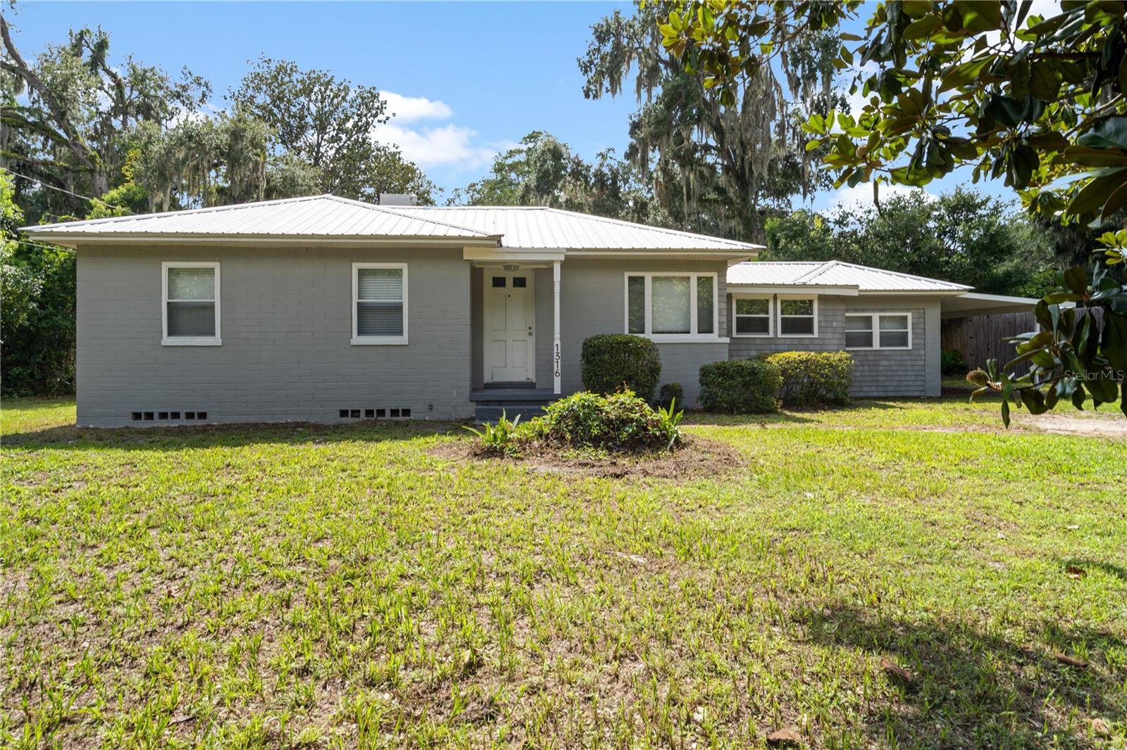 Step back in time with this beautifully preserved 3-bedroom, 1-bath vintage home, built in 1948 with original hardwood floors, Modern updated kitchen with an island/bar for an open and bright great room for ease in cooking and entertaining. A unique bonus: a detached freestanding studio or office. Whether you need a creative workspace, home office, guest retreat, or personal gym, this flexible space is full of potential—with its own entrance and plenty of natural light. . Mature landscaping with plenty of room for gardening on this 1/3 of an acre lot. All this with the convenience of being close to downtown, parks, restaurants, shopping & UF.