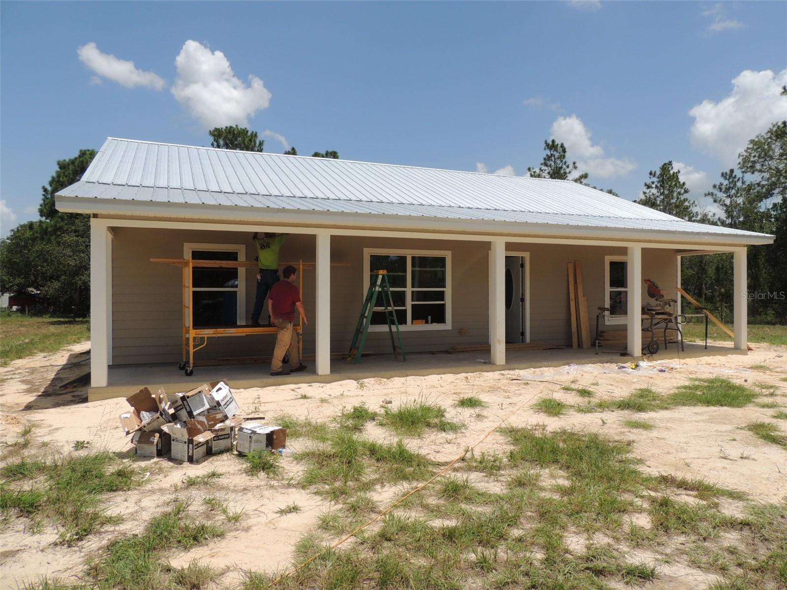 Under Construction. DISCOVER YOUR NEW HOME in WILLISTON. Nestled on a spacious 1 acre lot in the desirable Williston Highlands community, this brand-new 3 bedroom, 2 bath home will be ready to welcome you in late August. Enjoy the perfect blend of indoor and outdoor living with its durable metal roof and inviting covered porches. Inside, you'll find a beautifully designed interior featuring luxury vinyl flooring throughout. The modern kitchen boasts granite countertops, custom cabinets, and top-of-the-line appliances. With three cozy bedrooms and two modern bathrooms, including a luxurious master suite, this home offers ample space for your family. Don't miss out on the opportunity to make this exquisite property your own. HS Internet available from Fiber by Central Florida. Some of the photos are from a previous home from this seller. New photos will be added as construction progresses.