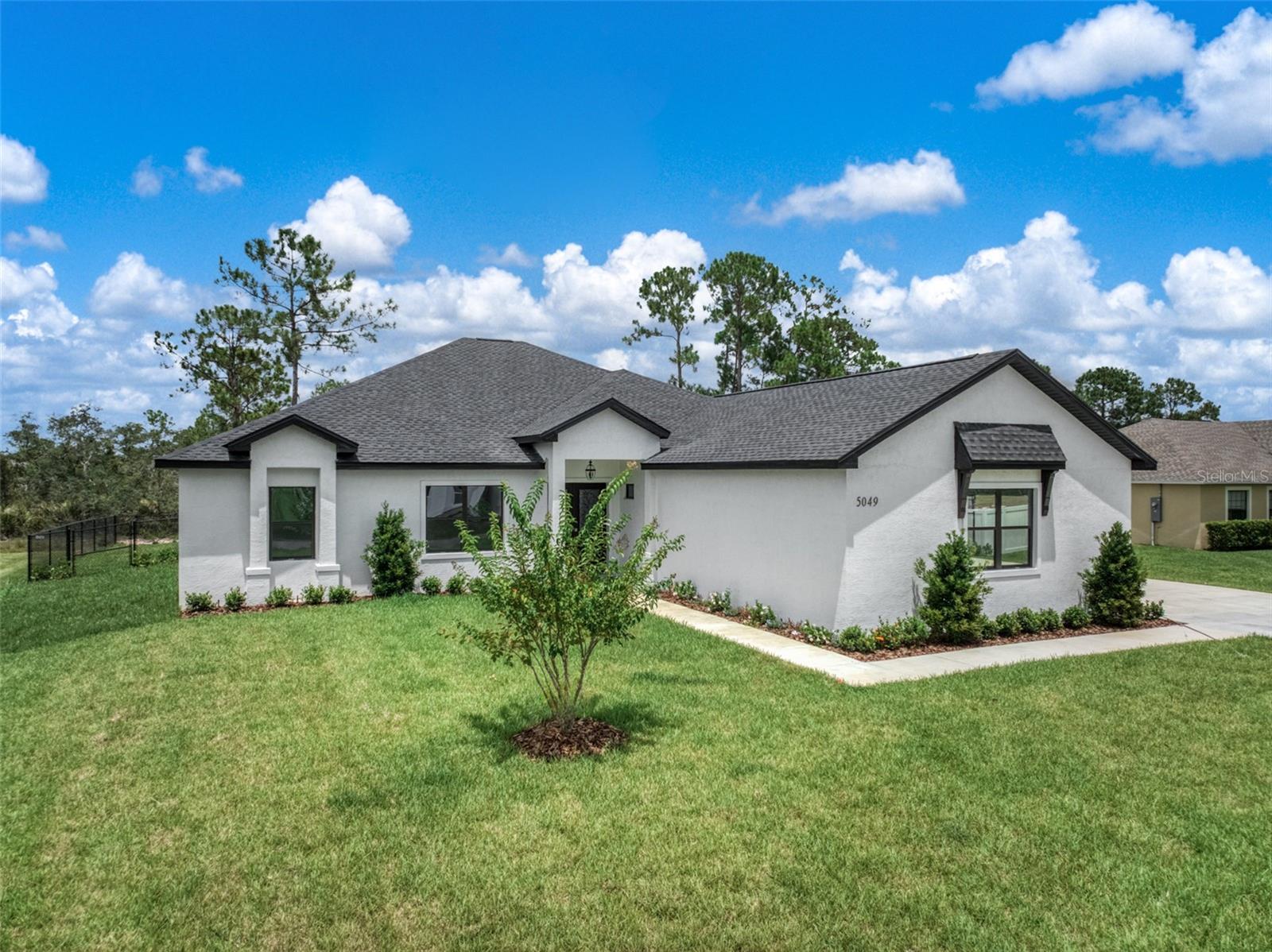 Under Construction. Beautiful custom home in the Manor Hill neighborhood in Sun N Lake of Sebring. Pictures shown of similar home and interior finishes of this home will vary. Double door entry, 10' ceilings, 4 bedrooms and 2.5 bathrooms. Luxury plank flooring throughout the home with tile in bathrooms and laundry. Stunning kitchen featuring granite counters, island with bar seating and premium cabinets. Spacious living area with lots of natural light, dining room with views of back yard and covered patio. Split bedroom floor plan. Luxurious primary suite and amazing en suite bathroom. Dual sinks on split vanity, private water closet and tiled walk in shower. 12,500 sq ft lot with room for pool and outdoor entertaining. Irrigation and landscaping included. This is an HOA with dues of $15/year. Small community surrounded by one of Sun N Lake's premier golf courses. This wonderful neighborhood offers a variety of amenities and activities for it's residents. Located in North Sebring with easy access to medical, emergency and shopping.
