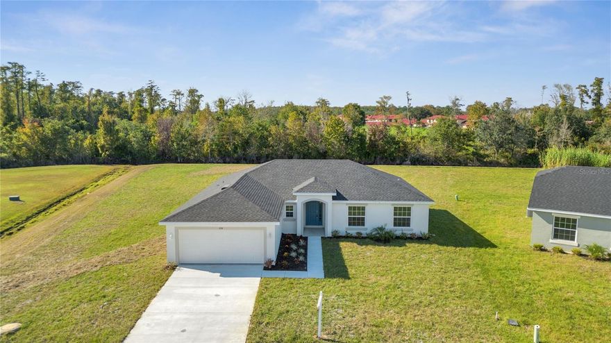 Welcome to Portico Homes' stunning "Cypress" model, offering the perfect blend of modern luxury and comfortable living on one of the biggest lots in town at over a half acre. No other builder in town has lots of this size! Located in the highly desirable Poinciana Villages Osceola County, this open-concept concrete block home boasts high-end finishes and many features throughout. Step inside to find elegant ceramic tile floors and plush carpeting in the bedrooms, setting the tone for a stylish and inviting living space. The Cypress model includes 42" cabinets in the kitchen and both bathrooms, along with sleek granite countertops that provide the perfect backdrop for your culinary creations.Indulge in the luxury of vaulted ceilings in the master bedroom, while the two massive walk-in closets offer plenty of storage space. Both bathrooms are fitted with generously sized tubs and modernly tiled showers, perfect for unwinding after a long day.