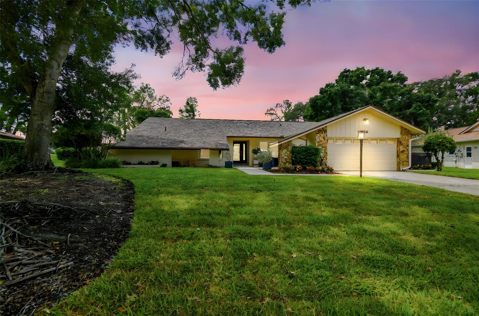 Welcome to your forever home located in the sought-after Carrollwood Village! This exceptional 4-bedroom, 2-bath home offers 2,031 square feet of living space and sits on one of the largest lots in the neighborhood. Walking up to this home you will notice a lovely courtyard offering outdoor seating space. The home’s floor plan begins with a lovely entry that flows into the formal living and dining areas. Two 3-panel sliding glass doors open to access a covered patio overlooking a lush, landscaped backyard, making this home perfect for gatherings. The landscape is easily maintained with a sprinkler and drip system. The kitchen boasts new Bespoke appliances and is truly the heart of the home, flowing nicely into both the formal areas as well as into the great room which includes vaulted ceilings and a fireplace. The bathrooms have been fully renovated with new Restoration Hardware fixtures, marble tiles and custom wood vanities. The laundry room features new front-loading washer and dryer and custom wood cabinets providing ample storage. Have peace of mind knowing that this property recently had a new roof installed (2023). The Carrollwood Country Club and Carrollwood Village Park are less than a mile away and include parks, tennis and basketball courts, golf, dog park, playgrounds, splash pad, and walking trails. This property is located within 6 miles from the Raymond James Stadium; 7 miles from Tampa International Airport; 9 miles from the University of South Florida; and 10 miles from downtown and the Amelie Arena.