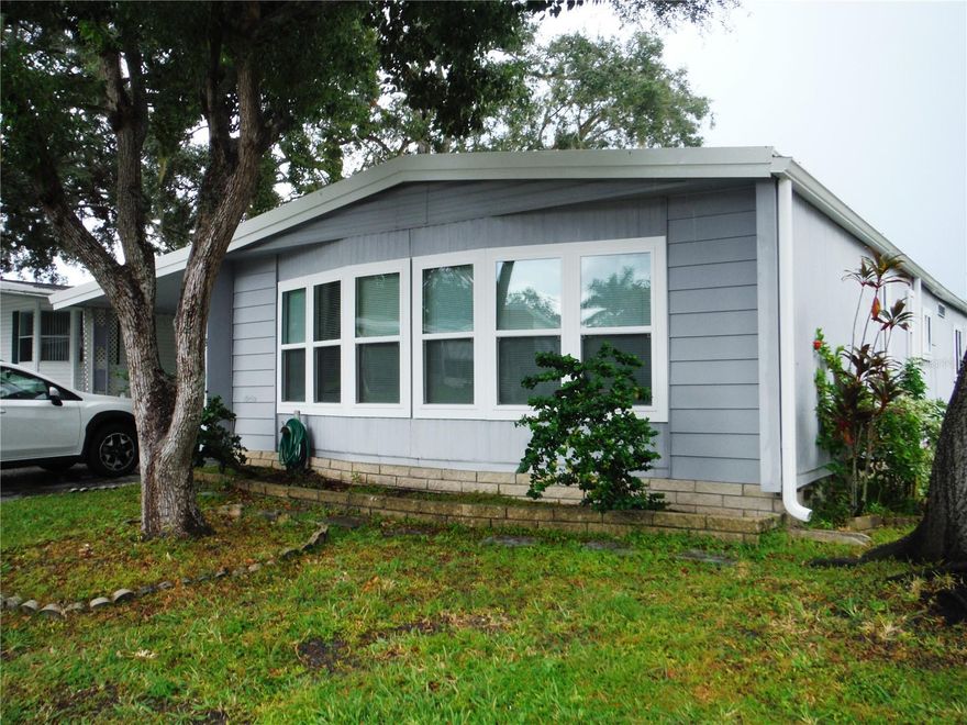 2 bedroom 2 bath 1356 square feet under central heat & air.  This furnished home also has a large enclosed side porch.  Windows were replaced and the roofover was also done in 2025. It has a spacious open floorplan and an island kitchen.  Bring your cat or your dog up to 25 pounds and enjoy the 55 plus community.  Your own deeded lot 52X75 is included in the price.  The maintenance fee is $241/Month and includes water, sewer, trash, private roads, clubhouse, heated pool & spa, shuffleboard, gym, and plenty of activities. Room measurements approximate.