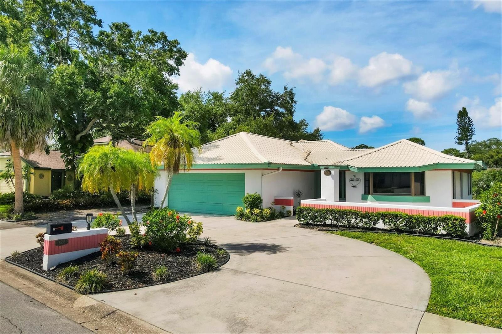 Discover the potential in this 2-bedroom, 2-bath home featuring a den/office, an oversize 2 car garage, soaring cathedral ceilings and serene lake views. With 1,702 SqFt of living space and filled with natural light, creating an airy and inviting atmosphere. A durable metal roof (2007) offers peace of mind, while the spacious layout provides a great canvas for your vision. Impact sliding door and window were installed in the guest bedroom, water heater replaced in 2020, and HVAC was replaced in 2017. Enjoy morning coffee on the back porch overlooking the tranquil water, and imagine the possibilities with some cosmetic updates and renovations to make it truly your own. Whether you're looking for a personal retreat or an investment opportunity, this property has great bones and unbeatable views—ready to be transformed into something special. Villa Amada was designed and built by the owner for his mother.