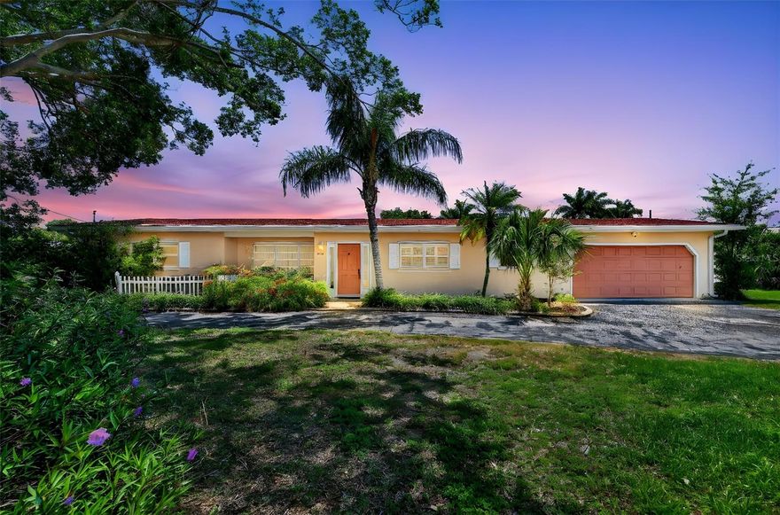 Located in the highly desirable Aqualane Estates, just about a mile from the world-famous Siesta Key Beach and Crescent Beach, and close to local favorite Captain Curt’s Crab & Oyster Bar, this unique property offers an incredible opportunity to own in one of Sarasota’s most sought-after waterfront neighborhoods. Surrounded by million-dollar homes and picturesque canal-lined streets, the setting alone makes this home truly special.

Set on an expansive 0.40-acre lot, the property is anchored by a stunning, majestic banyan tree that creates unmatched curb appeal and Old Florida charm. While the home does not offer full canal access, it does feature a small sliver of water frontage, adding to its character. With no HOA, you’ll enjoy added flexibility and freedom rarely found in such a prime location.

This oversized lot also presents exceptional potential for redevelopment, with ample space to build a new custom home in line with the luxury properties throughout the neighborhood—making it ideal for investors, builders, or buyers looking to create their dream home.

Built in 1956, this classic Florida-style home offers 3 bedrooms, 2 bathrooms, and 1,957 square feet of living space. Inside, you’ll find timeless character throughout, including beautiful terracotta tile flooring accented with unique hand-painted tiles, along with artistic touches carried into the primary bedroom and shower.

The outdoor space is designed for enjoying the Florida lifestyle, featuring a large, private pool ideal for laps, all enclosed within a fenced backyard and patio area for added privacy. A two-car garage with an attached workshop provides plenty of room for storage, hobbies, or projects.

Recent updates include a 2025 shingle roof and an upgraded lift station for the septic system, offering peace of mind for the next owner.

Whether you’re looking to enjoy it as-is, renovate, or build new, this property offers a rare combination of location, lot size, flexibility, and future potential just minutes from the beach, dining, and everything Sarasota has to offer.