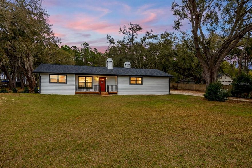 Welcome to 9642 Sunnyslope Lane in Wesley Chapel, a beautifully updated 3-bedroom, 2-bath home offering 1,870  square feet of living space on a full 1-acre lot, providing privacy, space, and flexibility rarely found in today’s market.
This home has been thoughtfully upgraded with major improvements already completed, including a NEW roof (2023), NEW well (December 2024), and NEW drain field (2025) — offering peace of mind for years to come. The fully renovated kitchen (2024) features quartz countertops, real wood cabinetry, and Samsung appliances, creating a stylish and functional space for both everyday living and entertaining. Additional updates include luxury vinyl plank flooring throughout, a NEW hot water heater (2024), NEW exterior paint (2024), NEW gutters (2024), and a NEW front deck (2024) that enhances the home’s curb appeal.

Inside, the home offers warm and inviting living spaces highlighted by two wood-burning fireplaces — one located in the living room and a second in the primary bedroom, adding charm and comfort rarely found in homes today.

Step outside to enjoy the large covered and screened lanai, perfect for relaxing or entertaining while overlooking the peaceful backyard with no rear neighbors, offering added privacy and a serene setting.

The expansive 1-acre property provides plenty of room for outdoor living, hobbies, or storage. Two separate outbuildings add incredible versatility: one shed with a garage door and electric, ideal for tools, equipment, or workshop space, and a second finished shed with LVP flooring, electricity, and a ceiling fan, perfect for a home office, gym, studio, or flex space.

The home also includes a washer and dryer, and the neighborhood features a voluntary HOA, giving homeowners flexibility without heavy restrictions.

Located in the growing Wesley Chapel area, this property offers convenient access to shopping, dining, medical facilities, and major roadways while still enjoying the space and privacy of country-style living.