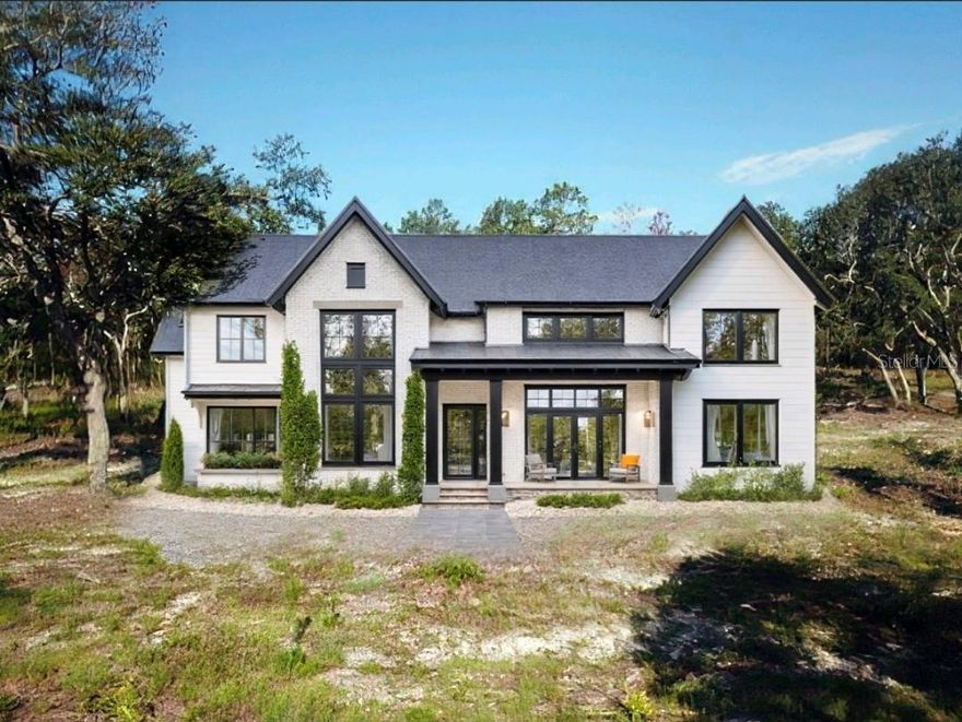 Pre-Construction. To be built. — A Southern Crown Custom Estate on 2.37 Private Acres
Set on 2.37 acres within a private four-home enclave, this to-be-built custom estate by Southern Crown Homes combines quality construction, thoughtful design, and the best of Florida country living. The community is zoned Agricultural Residential, allowing for up to two horses or cattle on each parcel, offering a rare balance of rural flexibility and refined residential appeal.
With 3,579 square feet of living space and 4,646 total square feet under roof, this home emphasizes open, functional living. Inside, two-story ceilings, expansive glass openings, and an open-concept great room create a bright, welcoming atmosphere. The kitchen features a large center island, professional-grade appliances, and seamless flow into the living and dining areas — ideal for both everyday living and entertaining.
The first-floor primary suite offers privacy and comfort with direct lanai access and a spa-inspired bath. A dedicated office and flex room on the main level provide options for work, fitness, or guest accommodations. An oversized first-floor laundry room adds convenience and utility, with plenty of space for storage and household organization.
Upstairs, a loft overlooking the great room adds architectural style, while two large secondary suites each feature walk-in closets and private bath access. A full laundry suite on this level provides additional functionality for multi-level living.
Outdoor living takes center stage with a spacious covered lanai designed for entertaining and a classic Southern-style front porch that adds timeless curb appeal. A side-entry garage maintains a clean front elevation and practical access.
Built exclusively by Southern Crown Homes, this residence is to be built and fully customizable, allowing you to personalize every finish and feature. Located in a private four-home community, this property offers space, privacy, and lasting quality — a custom home designed to fit both your lifestyle and your land.
* The land is available for purchase individually as is Centralia Trails Lot 1 (see MLS listing W7871184)
** This home can be built on Centralia Trails Lot 1 (see MLS listing W7871184)