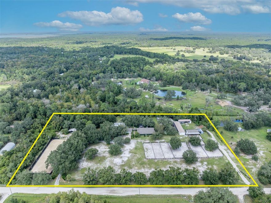 Owner Financing Available-see the end of description!!!   INCOME PRODUCING OPPORTUNITY OR MULTI GENERATIONAL LIVING!  Welcome to Beautiful Oviedo—this 7.5-ACRE ESTATE features three separate homes and top-tier equestrian facilities, making it perfect for a family compound, income-producing rentals, or a horse boarding business.

THREE HOMES, ENDLESS INCOME POTENTIAL..
MAIN HOME: A spacious ranch-style retreat with soaring ceilings, real wood floors, a cozy gas fireplace, and a wraparound porch. The covered back patio features a swim spa and retractable screen for ultimate relaxation.

GUEST HOUSE: A 2-bedroom, 1-bath home with beamed ceilings, an open floor plan, and a bonus room with washer/dryer hookups—perfect for rental income.

DETACHED STUDIO: Includes a full kitchen and bath, making it ideal for a short-term rental, caretaker, or home office.

EQUESTRIAN EXCELLENCE AND BUILT IN REVENUE...
11 STALLS (9 at 12x12, 2 at 14x12) with dual fans for comfort, 

Large TACK & FEED rooms, covered FARRIER area with electrical & private half-bath, 

200-foot RIDING ARENA with a silica-fiber base, irrigation, and professional-grade mirrors.

TURNKEY horse boarding potential—ready to generate income from day one!

PRIVACY, STORAGE AND CONVENIENCE...
With TWO GATED ENTRANCES, a 90-foot carport, and ample storage, this property blends functionality with country charm. Whether you seek a profitable rental and boarding business, a private retreat, or both—this estate offers limitless opportunity.

!!SELLER FINANCING 20% down, 5% interest for 15 years.!!