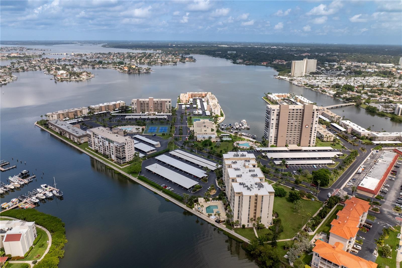 Get ready to experience the perks of St. Pete Beach living without the hassle in this Bay Island condo! Bay Island is a well-known and loved 55+, waterfront community. This exquisitely renovated 4th-floor condo combines modern sophistication with serene, tropical surroundings. As you enter, you'll be immersed in natural light and pleasantly greeted with a beautiful, turn-key living space. The stunning, custom kitchen is complete with soft-close cabinetry, an under mount sink, subway tile backsplash, recessed lighting, and Samsung appliances. The oversized quartz island allows for tons of prep space and breakfast bar seating. Every detail has been thoughtfully designed to blend elegance with functionality. The open-concept layout flows effortlessly into the spacious living room, where large hurricane-rated windows (updated in 2021) invite fresh air and again, provide a tremendous amount of natural light. Enjoy tranquil views of gardens and palm trees or use the newer custom sunshades (also 2021) for privacy. The location of this unit ensures that your home remains cool and comfortable, without direct heat from the sun. The primary boasts two custom-built, double closets and a walk-in closet, as well as a lavishly updated en-suite bathroom with stand up shower. Option to install a barn door for added bathroom privacy and style. The sunroom, offers endless possibilities – it could be used as your home office, work out room, dining room, additional living space or even add a pull out couch or Murphy bed and have a place for guests. The half bath has been equally refined with modern updates and is perfect for guests off the main entry. This unit resides in the highly sought-after Ambassador building, where luxury meets convenience. Enjoy the comfort and safety of the guard-gate and gated lobby. The building has two elevators, and climate-controlled, covered walkways—a unique feature exclusive to this building. This unit is right off the elevator exit, which is convenient for every day and for your move-in. The building also offers floor-specific garbage collection, trash chutes and a private storage locker. The community laundry room is located just one floor above and has many machines available for use. As part of the Bay Island community, you’ll have access to an array of wonderful amenities and activities. There are multiple pools and spas available for use, and one is just steps from your building's entrance. There are also outdoor grills and waterfront tiki huts, tennis courts, shuffleboard courts, billiards, ping pong, and a well-stocked library. The beautiful clubhouse also contains two exercise rooms with their own saunas and upstairs, an extra large banquet space with bar, dance floor, stage and table seating. Bay Island hosts many community activities like yoga, bingo and more so you can meet your neighbors and make fast friends. A scenic 1.5-mile waterfront boardwalk allows for peaceful strolls, where you can experience the Florida lifestyle and spot dolphins and manatees in their natural habitat. There is also a marina where you can fish off the dock or purchase a boat slip. Located just minutes from Corey Avenue and beautiful St. Pete Beach, you have access to charming boutiques and family-owned restaurants. Use the convenient Sun Runner as well to experience the vibrant energy of downtown St. Pete. This home offers the perfect balance of relaxation and excitement. Schedule your showing today!