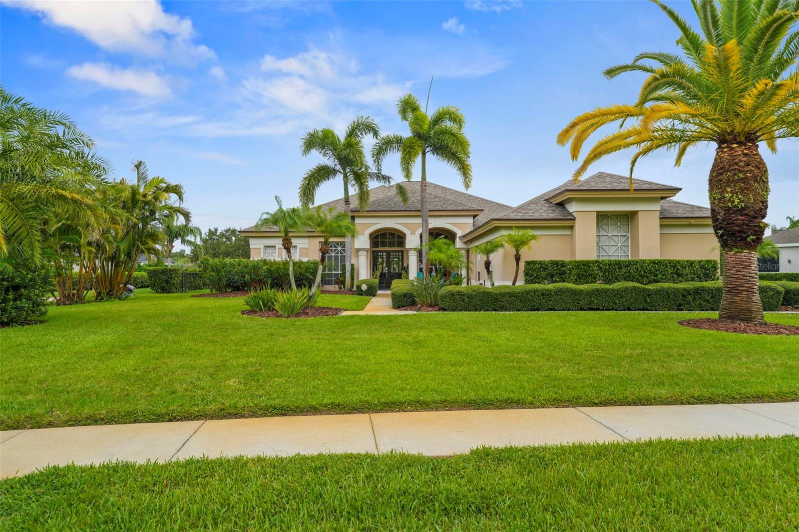 Exceptional Luxury Home in the Premier Community of Myrtle Point of Lansbrook. Step into a home where elegance meets comfort in this 3,037 sq. ft., 4-Bedroom, 3 Full Bath, Bonus Room, and Den masterpiece. This home offers breathtaking views of the pool, spa, and serene pond from nearly every main living area—creating a true sense of peace and connection to nature. From the moment you enter through the double wood doors, you’ll notice soaring high ceilings, newer tile floors throughout, and beautiful crown molding that set the tone for timeless sophistication. The open, split floor plan flows seamlessly, offering spaces for quiet moments and lively gatherings. The true centerpiece of the home is a designer kitchen featuring an oversized island with storage, KitchenAid stainless steel appliances, a convection double oven, and dual pantry closets with custom pull-outs. Entertain effortlessly with a dry bar featuring wine storage and a dual-zoned wine fridge holding up to 46 bottles. Enjoy the privacy of electric shades framing the spectacular water views in the main living areas. Your primary suite is a private retreat with high ceilings, lanai access, two walk-in closets, and a spa-inspired bath showcasing granite counters, dual vanities, a walk-in rain shower, and a MAXX jet tub surrounded by stunning tile. Step outside to your own resort-style oasis with a PebbleTec pool and spa, LED color-changing lights, a WiFi-controlled heater, and a saltwater system. The expansive screened lanai with paver flooring, large overhangs, and lush views creates the ultimate Florida lifestyle experience. Additional features include a new roof, brand-new secondary HVAC, surround sound throughout, a four-car garage, a mother-in-law suite, security system and cameras, and a fully fenced yard. Located within one of the area’s most prestigious neighborhoods with its oversized lot, this home offers access to top-rated schools and falls within the East Lake Middle School radius, making it an ideal choice for families. The property is also within walking distance to Lansbrook’s parks featuring jungle gyms, basketball courts, pickleball, soccer fields, and the private Lansbrook Lakefront Park with boat slips, a boat ramp, gazebo, walking trails, and more. Conveniently close to shopping, dining, and nature preserves, this home truly combines luxury, comfort, and smart design in one unforgettable package. A QUICK LOOK at the Highlights: NEW ROOF & SECONDARY HVAC SYSTEM, TILE FLOORS THROUGHOUT, PEBBLE TEC POOL & SPA WITH NEWER PAVERS, EXTERIOR PAVER AREA FOR AN OUTDOOR KITCHEN, FOUR CAR SIDE LOAD GARAGE WITH EXTRA PARKING AREA, OVER 1/2 Acre, MIL SUITE CAPABILITY, DEN WITH CLOSET, VIEWS OF POOL/SPA & LARGE POND, SPLIT FLOOR PLAN, HIGH CEILINGS, CROWN MOULDING AND LARGE BASEBOARDS, NATURAL LIGHT, UPDATED BATHROOMS AND KITCHEN, LARGE LAUNDRY ROOM AND CLOSE TO THE TOP SCHOOLS.