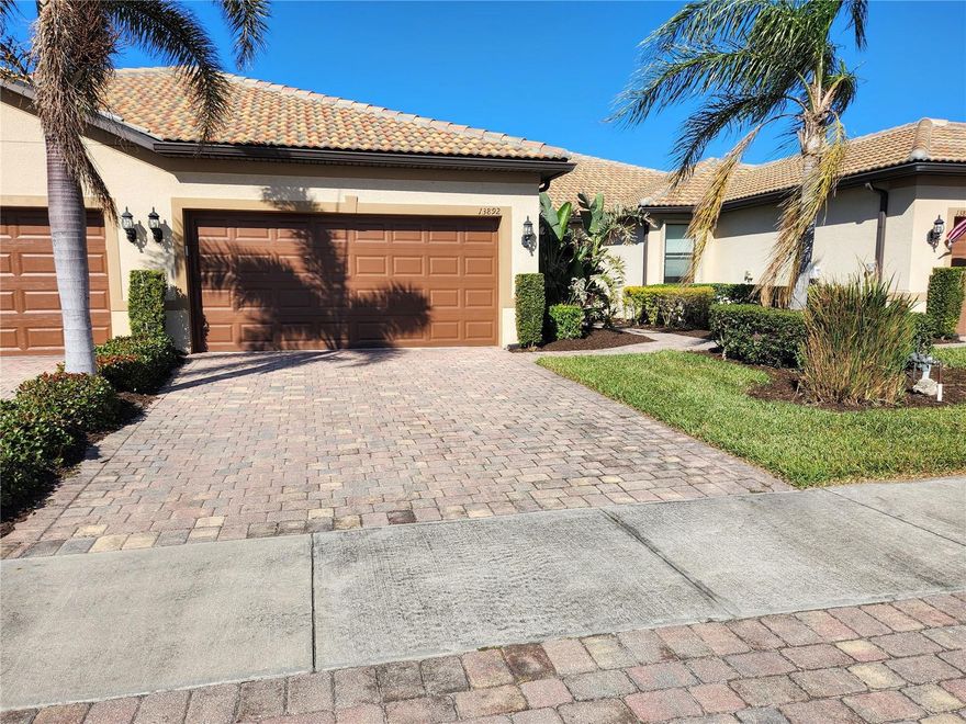 Experience a vacation lifestyle in the vibrant resort-style community of Islandwalk, packed with every amenity you could ever wish for. This stunning 2016 waterfront villa with new hot water heater and is being sold fully furnished, including wall art, a golf cart, and outdoor furnishings. The sectional sofa boasts three recliners, two of which are electric. The car is available separately. 
You'll appreciate several extras, such as the extended lanai overlooking the lake, a murphy bed in the flex room so you have a 3rd bedroom for guests, six-panel doors, chic ceiling fans, a laundry closet, hurricane and plantation shutters, a built-in desk in the kitchen, 42" cabinets with crown molding, a solar tube for added light, tile flooring throughout, a vanity space in the master bath, stainless steel appliances, an open floor plan, granite countertops, an epoxy-coated garage floor, pull-down attic stairs with decking for storage, a new quiet belt-driven garage door opener, a 200 amp electrical panel, and a reverse osmosis system in the kitchen for the sink and ice. 
Location-wise, this area of the community is conveniently close to the main gate and the clubhouse. Be sure to explore the fantastic amenities during your visit! Enjoy a lap pool along with two resort-style pools, a remarkable fitness center, twelve Pickleball courts, eight Har-Tru tennis courts, ping pong and pool tables, a library, playground, dog park, outdoor grilling area, basketball, and much more. The main gate provides access to Route 41, while the side gate leads directly into Wellen Park, where shopping, dining, and entertainment await at Tomahawk Tiki and the Atlanta Braves Stadium in Cool Today Park.
