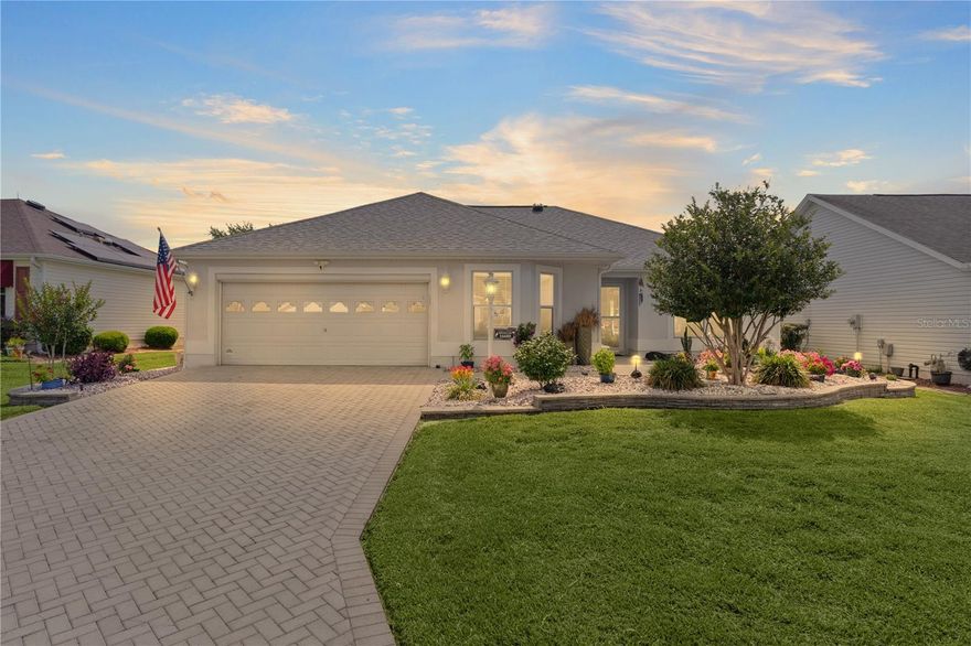 Beautifully maintained and loaded with upgrades, this Designer Jasmine Model is tucked away in the highly sought-after Village of Calumet Grove in The Villages, Florida — known for its majestic oak trees, rolling hills, and peaceful setting! Offered at $364,900 with NO BOND, this move-in ready home showcases stunning curb appeal and exceptional attention to detail throughout.
Step inside to an open, bright floor plan featuring laminate flooring throughout with NO CARPET, crown molding, solar tubes for natural light, updated lighting, and beautifully updated bathrooms. The spacious kitchen and baths feature NEW granite countertops, while the glass-enclosed lanai with sliding doors and automatic blinds creates the perfect year-round Florida living space.
Outside is where this home truly shines! The professionally designed hardscaping is absolutely spectacular with exclusive pink rock accents, custom irrigation to every decorative pot for easy maintenance, and gorgeous low-voltage landscape lighting that illuminates the property beautifully in the evenings. Every detail was thoughtfully designed to create a one-of-a-kind outdoor ambiance.
Additional upgrades include a 2019 A/C system, 2020 roof, tankless hot water heater, whole house surge protector, whole house water softener, central vacuum system, and an alkaline drinking water filtration system at the kitchen sink. Energy efficiency features abound with attic exhaust fans powered by both solar and electric, along with a soft-start compressor designed to reduce energy consumption and lower electric bills. The home also features new garage door openers, new sprinkler heads, updated lighting throughout, solar tubes for added natural light, laminate flooring with no carpet, crown molding, and beautifully updated bathrooms. The glass-enclosed lanai with sliding doors and automatic blinds creates an ideal indoor-outdoor living space perfect for enjoying Florida living year-round.
Close to the renowned Nancy Lopez Legacy Country Club with championship golf, this home offers the perfect blend of luxury, comfort, efficiency, and low-maintenance living in one of the most beautiful areas of The Villages!