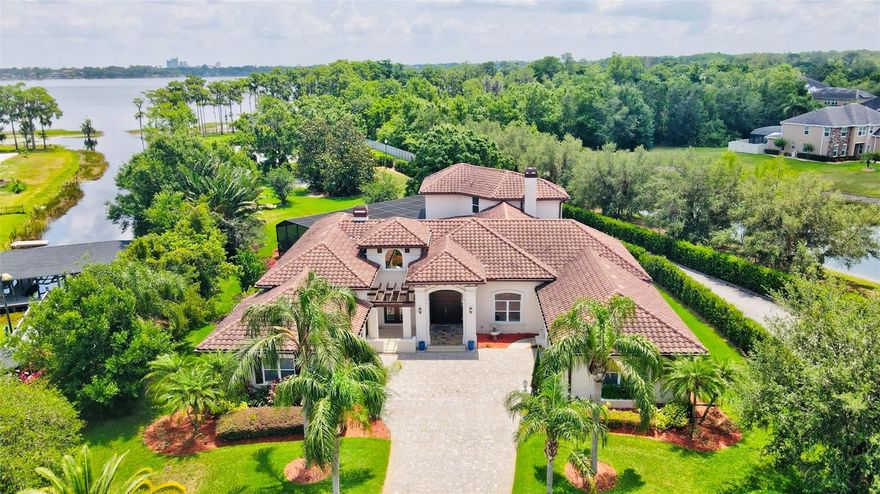 Welcome to an Elegant Lakefront Retreat on the Butler Chain of Lakes! Tucked at the end of a quiet cul-de-sac in a private, sought-after neighborhood, this rare waterfront estate offers an extraordinary combination of luxury, comfort, and the quintessential Florida lifestyle. Step into this beautifully maintained 4-bedroom, 3.5bathroom pool home, and be immediately captivated by the soaring ceilings, open layout, and sun-drenched living spaces that invite in breathtaking lake views from nearly every angle. The gourmet kitchen is both stylish and functional—perfect for everyday living or entertaining guests—with thoughtful touches throughout. Wine lovers will delight in the intimate wine cellar room, ideal for showcasing your collection and hosting tastings.
Upstairs, you'll find two spacious bedrooms, a cozy loft for lounging or working from home, and a private balcony that delivers panoramic lake views—a serene escape morning or night. Outside, your own private paradise awaits. A screened-in pool and spaoverlook the tranquil waters of the lake, providing the ultimate setting for sunset swims, outdoor dining, and unforgettable gatherings. For the enthusiast, the split four-car garage offers ample space for vehicles, toys, or a workshop. With direct access to the pristine Butler Chain of Lakes, your days can begin with sunrise paddles and end with sunset cruises. Luxury. Privacy. Waterfront Living. This is the lakefront dream—and it's waiting for you.
Schedule your showing today and experience the magic for yourself! Significant price reduction! Seller highly motivated—don’t miss this incredible opportunity!!
