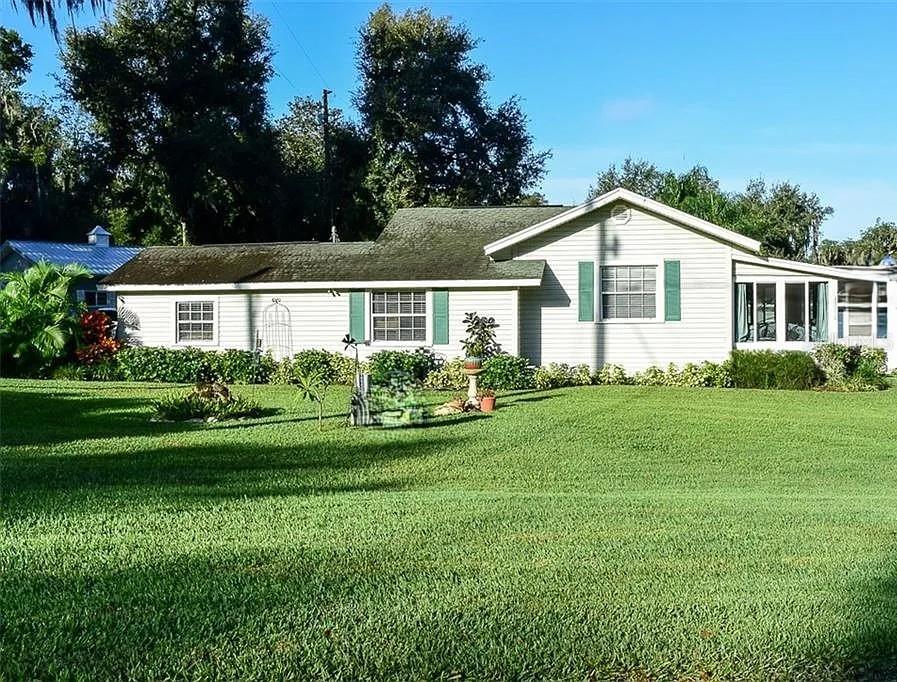 Quaint 1-bedroom, 1-bath cottage just steps from Lake Weir, offering a large enclosed Florida room with central air for year-round comfort. The spacious primary bedroom features a tray ceiling, dual closets and carpet. Upgraded vinyl flooring flows throughout the rest of the home complimented by natural lighting. Access from the laundry room leads to the exterior that includes a large storage shed, metal carport capable with RV accommodations, a paved patio and walkway, and fencing for added convenience.