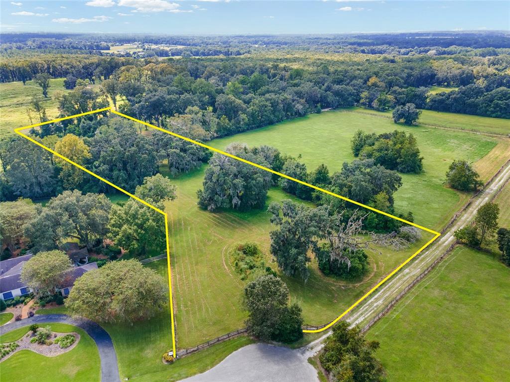 The owner of the land who developed Ivy Park held onto to simply the best lots of the nineteen parcels that were available, and now is the time for you to own this 2.26 acre cul de sac lot. Rarely are OPEN-BUILDER lots available in platted subdivisions for purchase…so take advantage! Lot 12 is located in the cul de sac of this one-street subdivision conveniently located off of 241 north/NW 143rd Street. Located under 10-miles to the University of Florida campus and UF Health, and only 8 miles to the Hunter’s Crossing Plaza where you will find Publix, local restaurants, Ace Hardware, and a nearby Starbucks. Enjoy the conveniences of city living in true picturesque country setting. This semi-cleared lot has scattered oaks inside and along its property lines. This lot 309 ft on its northern end. The right side of the lot is over 483 ft deep, with the rear property line spanning over 165 ft. Its unique shape allows you plenty of room to build your dream home with vast south and southwest private views and gorgeous star-filled nighttime skies AND have plenty of open space to enjoy the outdoors. If you’re an outdoor adventurist, travel just 5 minutes to the San Felasco Hammock Preserve State park which offers outdoor adventure to hikers, off-road bicyclists, horseback riders and nature lovers. The HOA has a voluntary, affordable annual fee, with deed restrictions still applicable to the subdivision. Open builder, beautiful private views, cul de sac location, and minutes to shopping, restaurants, Gainesville’s Regional Airport, and to UF. What more could you ask for? Buyers are to verify the property lines by obtaining their own survey. Property lines noted in pictures are approximate.