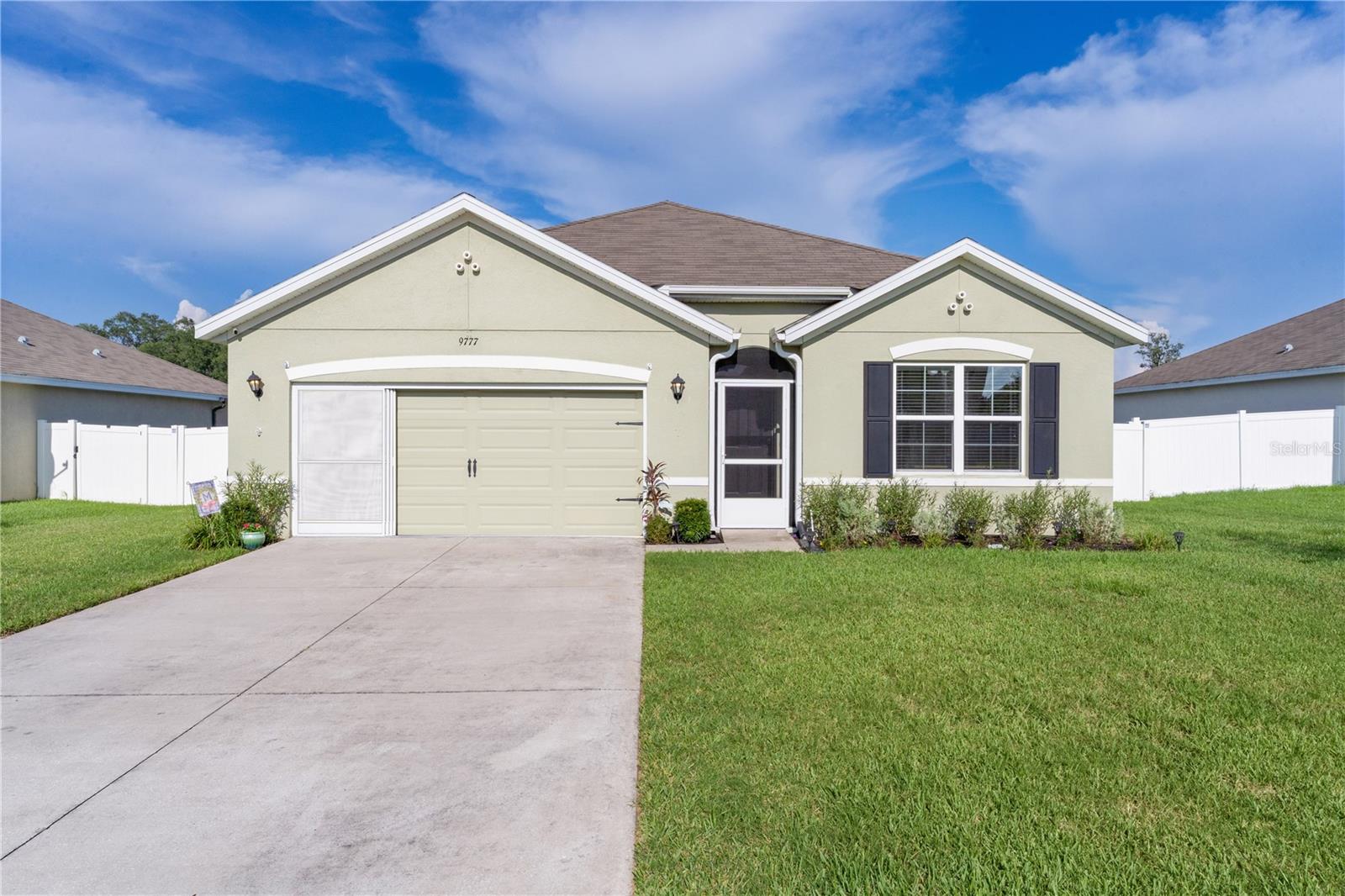 Don't miss this beautiful 4-bedroom 2 bath well maintained home! Built in 2018, this home is move-in ready!! Step inside to brand-new vinyl flooring and a bright, open-concept layout perfect for comfortable living and entertaining. The Kitchen shines with newer stainless-steel appliances and a practical design for everyday use. The spacious primary suite includes private bath while three additional bedrooms have flexibility for guests, an office, or hobbies. One of the standout features is the SOLAR PANEL SYSTEM, PROVIDING ENERGY EFFICIENTCY AND long-term utility savings--an ecofriendly upgrade that adds real value. Water softener AND purifying system recently installed. Enjoy a large FENCED in private backyard with room to create your ideal outdoor space, including a screened in Lanai. Whether you're relaxing at home or taking advantage of nearby shopping, dining, entertainment in The Villages, this property offers the best of both words. The Turnpike and I-75 close by! Call for your private showing today as this gem won’t last long…