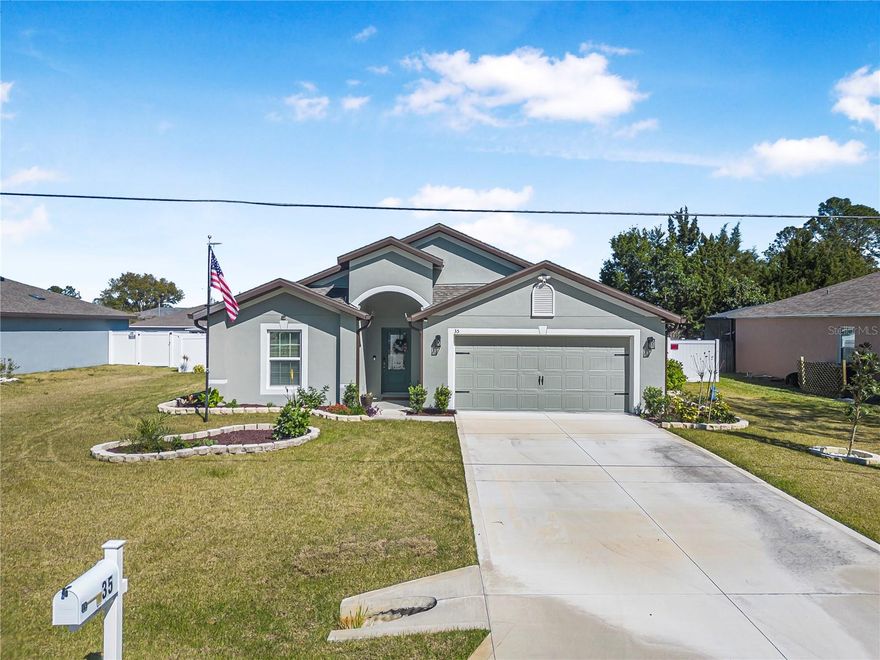 Built in 2023, this immaculate 4-bedroom, 2-bath home feels brand new—lived in for only a few months. The pristine exterior boasts upgraded Zoysia grass, lush landscaping, a fenced yard with two gates, a spacious shed with loft, and a flagpole for added curb appeal. Inside, enjoy luxury vinyl plank flooring, an open kitchen with granite countertops, stainless steel appliances, and stylish white cabinetry. The bright family room opens to a lanai overlooking a private backyard oasis. The primary suite features a walk-in closet and a large en-suite with double vanities, a garden tub, and a separate shower. Three additional bedrooms offer flexibility for guests or a home office. Additional highlights include a finished laundry room with subway tile, a meticulously upgraded garage with commercial tile flooring, a generator with a 100 lb. propane tank, irrigation system, alarm and camera security, keyless entry, blackout drapes, upgraded lighting and outlets, and smart home features throughout.