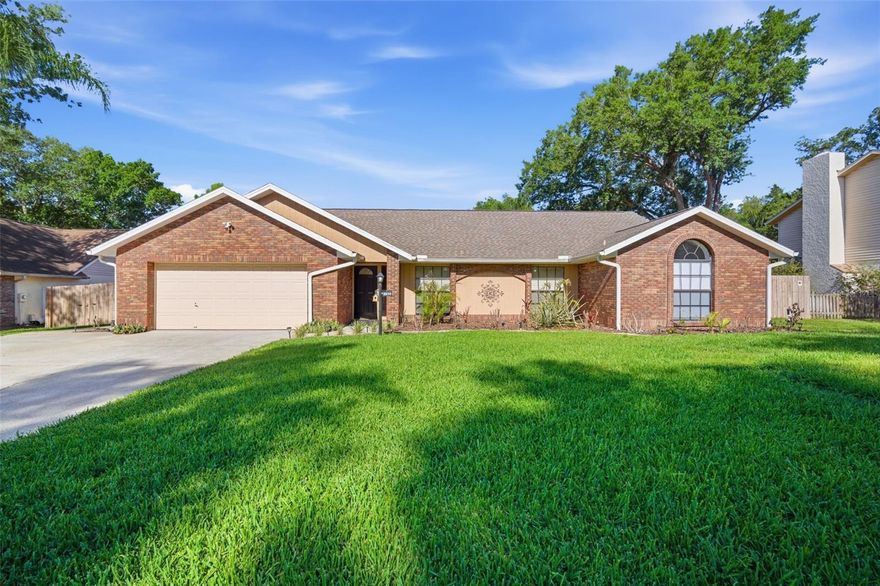 Wonderfully loved POOL/SPA home filled with brick accents and timeless charm, tucked away on a cul-de-sac with NO HOA and sitting on over 1/3 of an acre- a rare find for those needing space and flexibility for a larger or growing family. This warm and welcoming home is truly one of a kind, and you will feel it the moment you step inside. Offering 5 bedrooms, an in-home office, and a bonus room just off the pool, this home is designed for both everyday living and  joyful gatherings. Engineered wood floors greet you at the front entry, with the home office immediately to your right behind double French doors. Just a few steps in to a charming kitchen featuring a huge U-shaped center island with seating for up to 12, making it the natural hub of the home. Knotty pine cabinets bring warmth and character along with abundant storage, while the brick arched wall over the gas stove creates a cozy, inviting space that feels like the heart of the holidays. Cathedral ceilings with exposed beams carry into the spacious family room, where a brick hearth and wood-burning fireplace anchor the main living area. Just off the pool deck, the bonus room becomes the most fun space in the house—perfect for darts, games, or simply relaxing after a swim. The primary suite is privately located on one side of the home and features sliding door access to the pool, walk-in closets, and a spacious bathroom with dual vanities, a walk-in shower, and a garden tub. Toward the front of the home, one secondary bedroom offers a perfect option for a nursery, while additional bedrooms are located on the opposite side, sharing a full bath and convenient laundry room. The outdoor living area is made for entertaining, with a gas-heated pool and spa, an oversized deck, and a fully screened enclosure with an 'under-roof' covered lanai. The fully fenced backyard is enhanced with brick pavers leading to a custom fire pit area and  cornhole lane - ideal for hosting family and friends. Additional features include a detached 1-car garage with electric with an extended brick paver walkway connecting the lanai, extra wide driveway with space to park up to 6 cars, and the extra-deep 2-car garage with abundant storage. Major updates provide peace of mind, including septic/drainfield/pump (2019), roof (2016), garage roof (2025), gas pool heater (2023), two HVAC units (2019), new fence (2025), and gutters/downspouts/French drains (2022). Located within walking distance to Bloomingdale high school and central to shopping, dining, I-75, and the Crosstown Expressway, this home offers both convenience and comfort with room to truly live. This is a must-see. It’s good to be home.