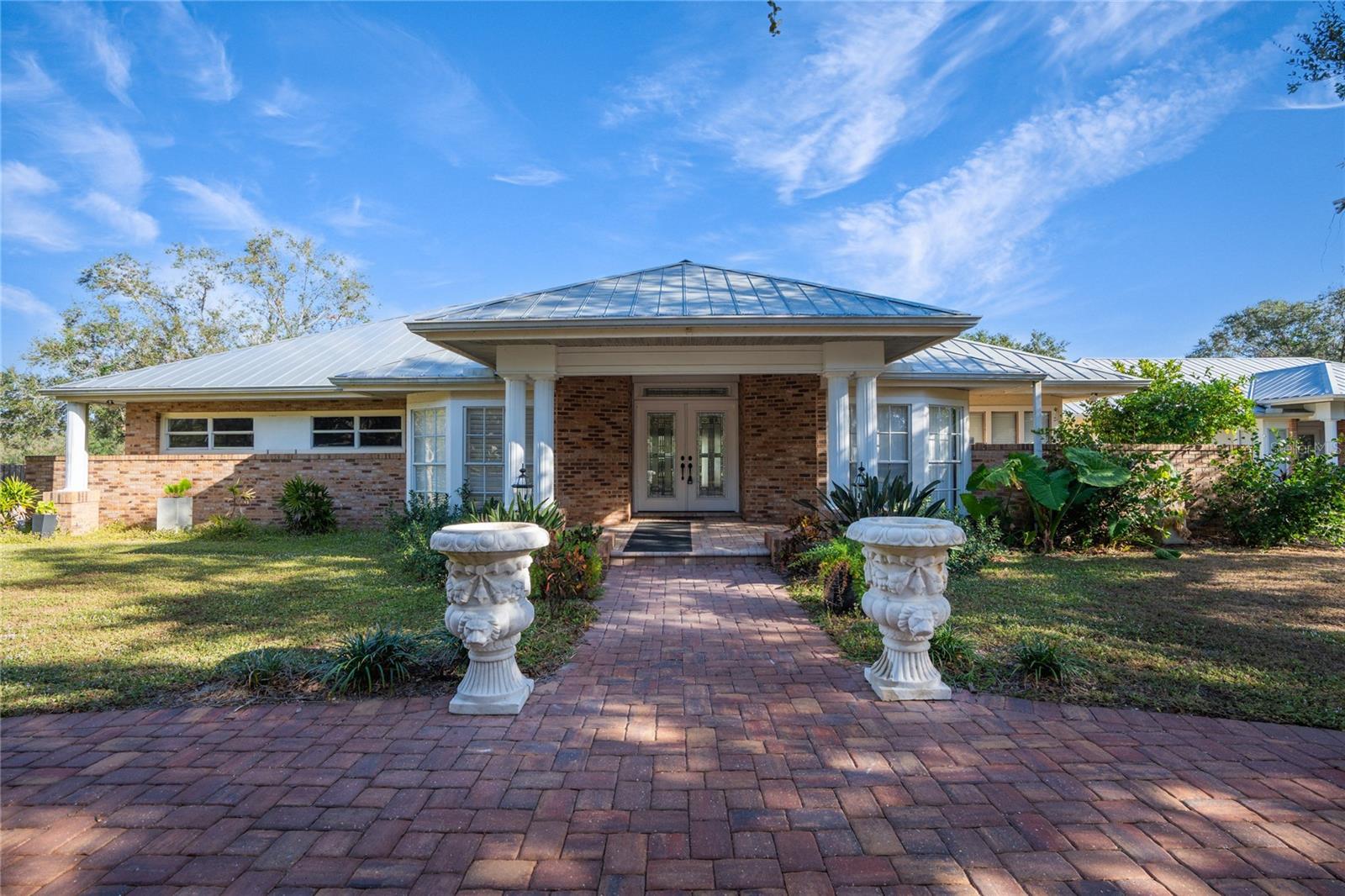 Live the peaceful country lifestyle while being just minutes to town. This stunning 2,500 SF custom home sits on 5 fully fenced acres in the heart of Sarasota and includes all utilities ! The open floor plan is light and bright and features 3 bedrooms , 21/2 baths plus a den with gorgeous stone and hardwood floors throughout. The updated kitchen includes beautiful wood cabinets with granite counters and open to the family room with a wood burning fireplace. There is a formal living room and dining room as well as a screened lanai overlooking the pastures, horses and lush greenery. Additional highlights are a 2 stall barn, 3 separate pastures and a tranquil pond. Enjoy total privacy and a country feel while still being close to everything Sarasota has to offer. Perfect for nature lovers, equestrians or anyone seeking space and peace. Bring your horses or simply enjoy the serene views of this incredible estate.