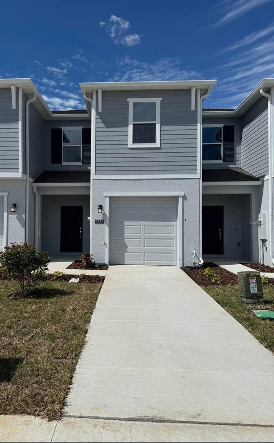 Welcome to your brand-new home at 2967 Maloof Drive, Davenport, FL!
This stunning two-story townhome, built in 2025, is located in the beautiful and growing Brentwood community. Offering approximately 1,787 square feet of modern living space, this residence perfectly combines new construction quality, stylish design, and a convenient location just minutes away from shopping, dining, and world-class attractions.
Step inside and immediately feel the spacious and bright open-concept layout that seamlessly connects the living room, dining area, and kitchen. The modern kitchen is equipped with elegant finishes, ample cabinetry, and a large island ideal for casual meals or entertaining guests. The open plan creates an inviting atmosphere perfect for family gatherings or relaxing evenings at home. Sliding glass doors lead to a private covered patio, offering a perfect spot to enjoy Florida’s warm weather and peaceful sunsets.
Upstairs, you’ll find a flexible loft area that can serve as a home office, playroom, media space, or additional lounge. The two secondary bedrooms are spacious and bright, sharing a well-appointed bathroom. The primary suite is your private retreat — featuring a generous layout, a large walk-in closet, and a luxurious en-suite bath designed for relaxation. Every detail in this home reflects modern comfort and thoughtful design, from the open flow of the living areas to the serene ambiance of the bedrooms.
The Brentwood community provides a resort-style living experience with amenities designed to enrich your lifestyle. Residents enjoy access to a sparkling swimming pool, playground, and clubhouse, offering opportunities for recreation, fitness, and socializing. Whether you’re enjoying a weekend by the pool or meeting neighbors for a community event, Brentwood offers the perfect blend of leisure and convenience.
Location, location, location! This home is ideally situated close to everything you need. Within just 5 minutes, you’ll find a Walmart Supercenter for groceries and everyday essentials. About 8 minutes away is Target, along with other popular shopping and dining options. For those who love adventure and entertainment, you’ll be delighted to know that Walt Disney World Resort is only about 20 minutes away, giving you quick access to world-famous theme parks, restaurants, and attractions. The property is also conveniently located near Highway 27 and Interstate 4, making commuting to Orlando, Tampa, or surrounding areas simple and efficient.
This unbeatable location allows you to enjoy the tranquility of suburban living while staying close to major employment centers, entertainment venues, and shopping districts. It’s the perfect combination for those seeking both relaxation and accessibility.
With its brand-new construction, stylish design, and excellent proximity to shopping and attractions, this property is a fantastic choice for families, professionals, or investors. Whether you’re looking for your first home, a vacation retreat, or a low-maintenance investment property, 2967 Maloof Drive offers everything you could want — comfort, quality, and convenience in one of Davenport’s most desirable new communities.
Don’t miss your chance to own this exceptional home. Schedule your private showing today and discover the modern Florida lifestyle waiting for you in Brentwood at Davenport — where everyday living feels like a vacation.