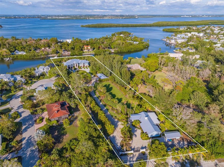 Expansive, gated, waterfront family estate featuring custom designed main home along with a separate three bedroom guest home. Enjoy private deeded beach access and deep water dockage.  
This Private two acre gated estate on the north end of Longboat Key is a rare gem.  Entrance, Driveway and Main home are illuminated with Bevelo gas lanterns.  Property includes 4 parcels total including 500 Nomas Way, 510 Nomas Way, 520 Nomas Way and 6680 Gulf of Mexico Drive. All are buildable lots.  There is a Separate 3 bedroom, 2 bathroom, 1850 square foot Guest House (500 Nomas Way) on the property with detached garage. Great for guests or staff. Enjoy 165' on the water with 2 docks and 3 boat lifts on Bishops Bayou with deep water direct intracoastal access. Deeded beach access to Gulf Of Mexico directly across Gulf of Mexico Drive makes the beach and sunsets a daily necessity.  Free form 15,000 gallon resort style pool with 1000 gallon spa. Pool has heat and chilling capabilities with reverse heat pump and natural gas. There is a 900 bottle red cedar wine cellar. Oversized custom built wood burning fireplace with gas option. Kitchen with natural gas, all Wolf and Subzero appliances. Plenty of room for your toys in any of the 6 garages with automotive lift. State of the art home automation and sound system throughout home.  50ft by 24ft covered pole barn.  24 camera security system monitors entire property so this home provides total peace of mind.    
It is truly a costal paradise.  This estate is a designer's dream, that exudes sophistication and class.
There is  a sense of balance and harmony. Indulge in the finest quality architecture while taking in the magnificent views. The  resort style pool area with an expansive custom built chiki provides endless entertainment possibilities. This home is a masterpiece.
Property boasts a Safe room, elevator and  60kW natural gas generator that keeps the entire home running regardless of any inclement weather.  Owner has Complete security as property is entirely gated and fenced.