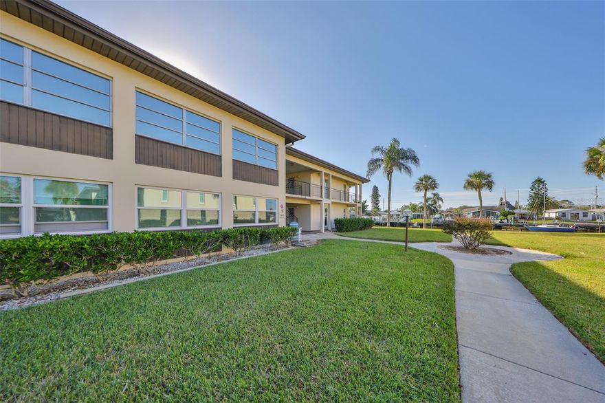 Welcome to this beautiful waterfront condo, located at the Gulf Harbors Condo in New Port Richey. Featuring stunning views of a deep-water canal that opens up to the Gulf of Mexico! This fully furnished one-bedroom retreat provides an incredible opportunity to convert a part of the living area back into a second bedroom with a partition wall, as it already has a closet and a private  sliding door, giving you the freedom to suit your needs. When you first enter the unit, the warmth of the stunning Brazilian teak wood floors that cover the whole living area will captivate you. The Florida room creates a calm ambiance by allowing natural light to flood the space. Enjoying a cup of coffee or a good book while taking in the gorgeous waterfront surroundings is the ideal way to relax! This floor plan is made more functional by an extra closet off the Florida room, which provides more space for storing your possessions. This condo unit lets you customize it to your tastes- whether you like an open living area or a private retreat. In your primary suite you will enjoy a spacious walk-in closet. Outside, there is ample parking with a reserved covered carport and open parking for visitors, and additional exterior storage closet. The laundry facility is located on the first floor of the building for your convenience. There are a lot of activities in the community, such as swimming in one of the two pools (one is heated), meeting new neighbors at the shuffleboard or bocce ball courts, playing billiards, and using the two clubhouses. Go down to the waterfront and watch the wildlife, enjoy the sunset, or take a stroll on the private beach. Enjoy a private beach with a Gulf Harbors Beach Club membership, which offers cabanas, grills, and stunning views on a 1/4 mile stretch of beach directly on the Gulf of Mexico. This condo unit had NO DAMAGES caused by recent storms. The Condo Association is not age restricted, and rentals are allowed after one year of ownership. Come enjoy true Florida living at its finest. Schedule your showing right away and fall in love with this MILLION DOLLAR VIEW condo!