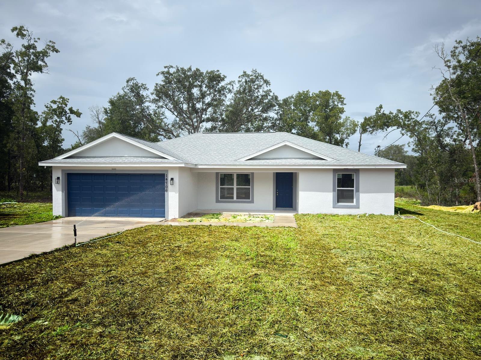 Stunning New Build in Ocklawaha – A Must-See! Discover this gorgeous, newly constructed home nestled in the serene setting of Ocklawaha. From the moment you arrive, you’ll notice the thoughtfully placed spotlights that brighten all four corners of the property, adding both style and security. Step onto the inviting back porch, where a ceiling fan ensures your comfort as you relax outdoors. Inside, the open floor plan immediately impresses with its modern finishes and elegant design. The kitchen and bathrooms feature luxurious quartz countertops, while recessed lighting bathes the entire living area in a warm, welcoming glow. The kitchen is fully outfitted with essential appliances, including a dishwasher, refrigerator, stove, and microwave, ensuring this home is truly move-in ready. Enjoy the privacy of a split floor plan, with the spacious master suite thoughtfully separated from the guest bedrooms. The master bedroom is a true retreat, featuring a tray ceiling, a large walk-in closet, and an en-suite bathroom with upscale touches. On the guest side, the generously sized guest bedrooms are complemented by a well-appointed guest bathroom, offering comfort and convenience for family and visitors. Modern light fixtures and ceiling fans are thoughtfully placed throughout the home, enhancing every room with style and practicality. As an added bonus, Spectrum internet service is available, ensuring you stay connected in your new home. Don’t miss your chance to own this beautiful property! Schedule your showing today and experience everything this home has to offer.