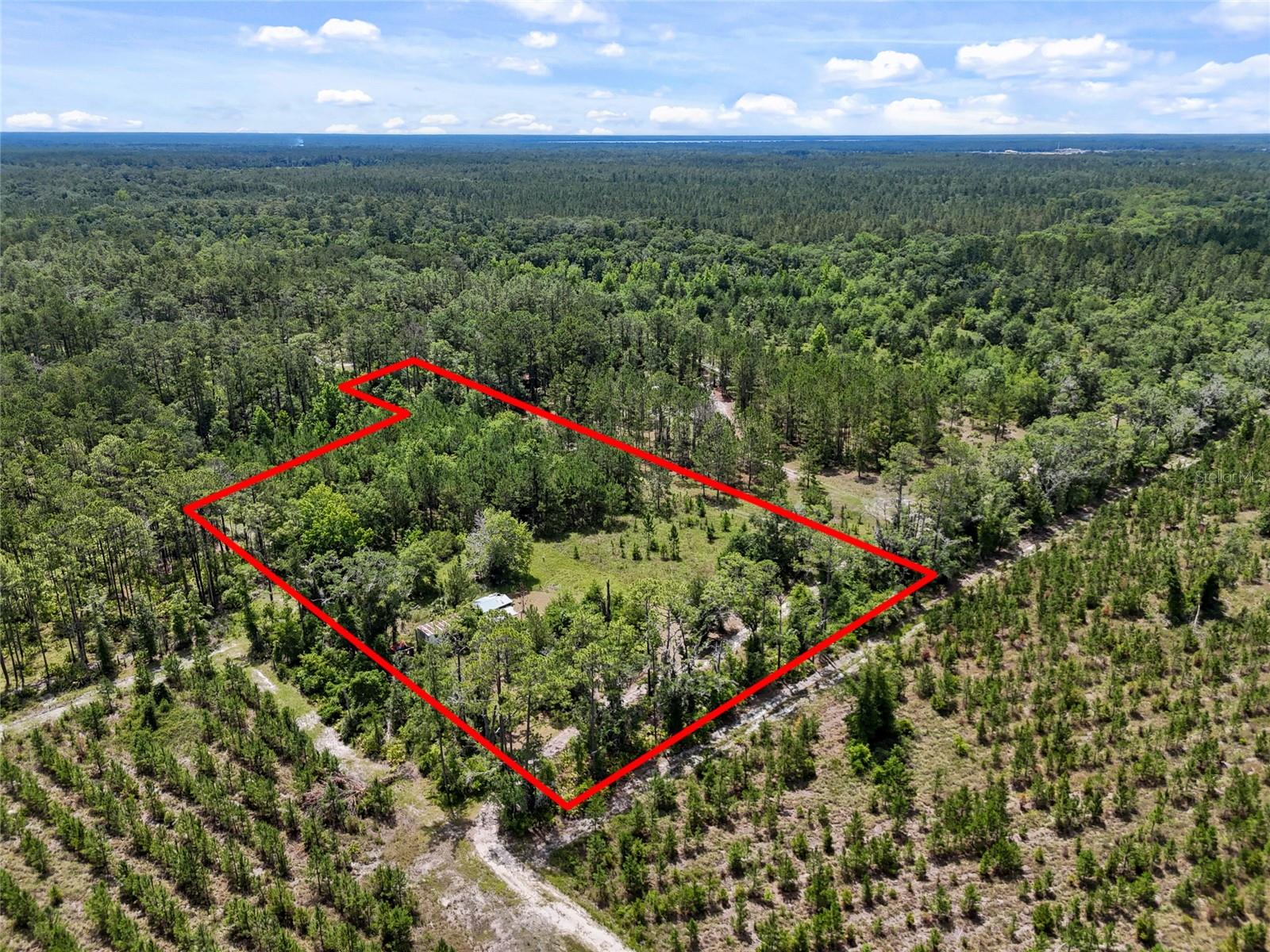 Endless possibilities await on this 3.98-acre property just minutes from downtown Gainesville! While the existing mobile home is in need of full renovation or removal, the true value lies in the expansive acreage and prime location. This is a perfect opportunity to build your dream home, create a private retreat, set up a small farm or homestead, or invest in future development. Enjoy the peace and privacy of nearly 4 acres while staying close to shopping, dining, hospitals, and the University of Florida. Whether you're an investor, builder, or someone ready to craft your ideal living space, this property offers flexibility, space, and potential. Don’t miss your chance to own a piece of land with room to grow in Gainesville!