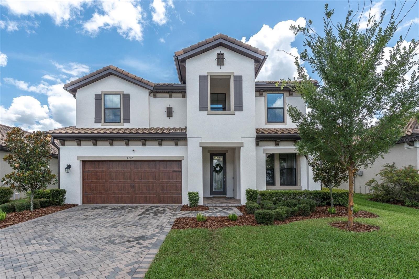 Under contract-accepting backup offers. EXQUISITE MODERN HOME IN DESIRABLE STARKEY RANCH! This beautifully designed Homes By WestBay Avocet II built in 2022 including transferrable warranty is located in Albritton in the Heart of award-winning Starkey Ranch, situated on a fully fenced lot within walking distance to Albriton pool & park and biking distance to Starkey K8! This incredible 2 story floor plan offers 3336 sqft featuring 5/3/3 car tandem garage + first floor office, guest suite & huge second story bonus room. You will appreciate many upgrades throughout like a coastal wood-look tile on the first floor in all main living areas, modern custom lighting w/ Hue Smart lightbulbs, Custom curtains & rods, Vivint Security system & a neutral Sherwin Williams paint throughout. Exterior elevation has elegant curb appeal thanks to shutters, barrel tile roof, paver driveway, landscaping, & front porch on a quiet street. A decorative front door w/ glass inlay & iron detail greets guests. The foyer welcomes you in. To the right is double French doors leading to the dedicated office. As you continue into the Grand Room, the open floor plan unfolds. Entertain your guests effortlessly in the Avocet II as the spacious kitchen overlooks the Grand Room with an adjacent dining space. The heart of the home, the Gourmet chef’s kitchen, is equipped with stainless steel appliances featuring stylish hood, 5 burner gas range, built in microwave, new BOSCH dishwasher & 4 door Samsung refrigerator, all of which stay with the home! A multitude of 42’ Maple wood White Shaker cabinets & drawers fashioned with crown molding & beautiful, brushed nickel hardware, accented by a subway tile backsplash, offers plenty of storage for the cooking enthusiast. The enlarged island with showstopping Cambria Britannica quartz counters, pendent lights & space for 4 bar stools. The dining room, highlighted by chandelier, offers ample space for a dining table. The kitchen is open to the Living Room featuring attractive ceiling fan, sliders to patio, & space to support any furniture configuration. Off the Living room, is a 1st floor guest suite. The full bath serves as guest bath & future pool bath w/ access door to the outdoor patio. At the top of the stairs you will find one of the most outstanding features of this home; the extraordinarily large bonus room!! The secluded, 2nd floor Primary Br is light and bright offering windows, ceiling fan, and a cozy extra sitting area. Escape to your luxurious Primary ensuite with tile floors, quartz counters, dual sinks, make up counter, cabinets & drawers, huge L-shaped walk in closet, sunken garden tub & upgraded walk-in shower with floor to ceiling tile. In this split floor plan, 3 additional bedrooms, 2 w/ ceiling fans, and bath 3 w/ tub shower combo allow for functional living. Conveniently located on 2nd floor, the Laundry room includes washer & dryer plus utility sink! Covered patio offers a shady space to relax under the breezy ceiling fan. The large yard is fully fenced yard provides privacy and safety. *Hurricane Shutters * Tankless Gas hot water heater *Garage storage racks* Water Softener & Kitchen Reverse Osmosis* Award winning Starkey Ranch offers K-8 Magnet Schools with themes of Fine Arts, Computer Science, & World Languages with a Community Library, Theater & Cultural Center; 3 community pools; 3 playgrounds; 3 dog parks; 20 mile trails & garden. Starkey Ranch Publix, Restaurants; & shopping! Schedule your showing today!