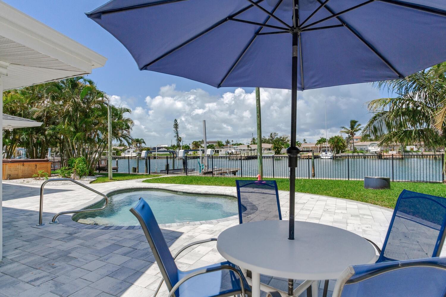 105’ WATERFRONT - FULLY FURNISHED & MOVE-IN READY - Welcome to your dream waterfront retreat in the heart of Treasure Island’s coveted Isle of Capri. This fully renovated, west-facing home sits on an oversized lot with an exceptional 105 feet of waterfront and 120 feet of depth offering beautiful water and sunset views and direct Gulf access via John’s Pass. Inside, every detail has been thoughtfully updated to create a bright, open-concept living space perfect for both everyday comfort and entertaining. Natural light fills the home, highlighting the seamless layout and high-end finishes throughout. The show-stopping kitchen features new stainless steel appliances, abundant counter space, and effortless flow into the dining and living areas. A flexible sitting area offers the potential for a third waterfront bedroom, ideal for guests or home office use. Step outside to your private backyard oasis. Enjoy the sparkling saltwater pool, unwind in the six-person spa under the stars, or relax on the beautifully sodded lawn surrounded by a newly updated irrigation system using reclaimed water. Boating enthusiasts will love the private dock, complete with a heavy-duty boat lift, jet ski lift, and a slip for larger vessels ,making days on the water easy and convenient. Additional upgrades include a new roof, updated electrical panels and new appliances throughout! This home offers true peace of mind and turnkey luxury, all fully furnished and ready for immediate enjoyment. Don't miss this rare opportunity to embrace the ultimate coastal lifestyle. Schedule your private tour today and start making memories in your new waterfront paradise.
