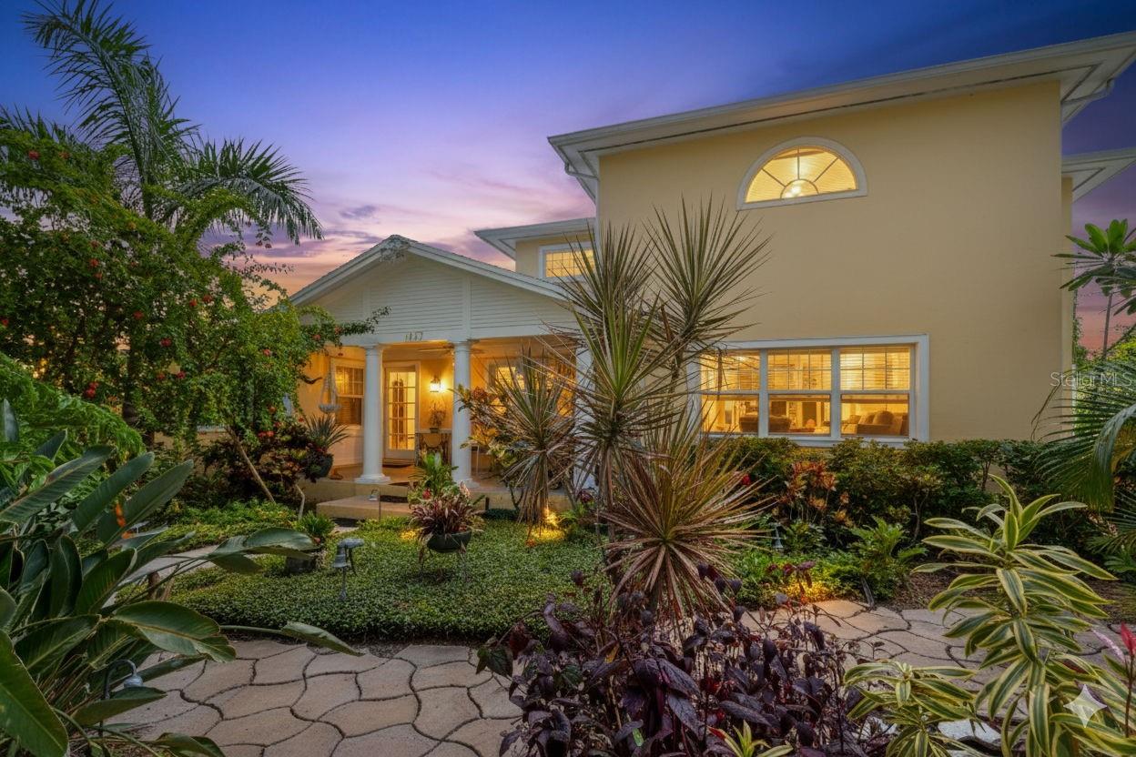 PRIME LOCATION in the highly sought-after Old Northeast neighborhood of St. Petersburg. This light and bright three-bedroom, three-bath block construction home with a den is perfectly situated just steps from the waterfront and a short stroll to vibrant downtown St. Petersburg. Nestled on a spacious 84 x 110 prestigious corner lot, the property boasts lush tropical gardens and multiple covered and outdoor seating areas, perfect for enjoying the best of Florida living. While the home has been updated over the years, it presents a wonderful opportunity for its next owner to make this location their own. The downstairs features an open and spacious layout, ideal for entertaining, including a large living room, dining room, sunroom, den, kitchen, and a convenient bedroom with an en-suite bath. Bringing in groceries is a breeze with direct access from the attached two-car garage into the home or the laundry room, which offers a sink with folding counter and ample storage. Additionally, a wet bar with built-in cabinets and a wine cooler enhances the entertaining possibilities. Upstairs highlights include a large primary suite with a spacious walk-in closet, shower and soaking tub, and a second bedroom with a full ensuite bath. Plenty of parking is available in the oversized two-car garage or on the parking pad behind with alley access. Schedule a private showing to fully appreciate this unique property in a great location!