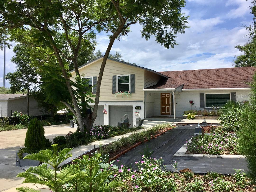 Check out the PRICE ADJUSTMENT on this immaculately maintained, move-in ready home!! Spacious, 5 bedroom, 3.5 bath, tri-level home with all the peace and comfort you desire, is located in the heart of beautiful Babson Park! The home sits on .58 of an acre and boasts lovely garden and nature views from every angle. Completely fenced and thoughtfully designed, the grounds have mature, graceful trees, a multitude of fruit bearing vegetation (banana, papaya, ginger, avocado, gandules, pineapple, peppers, & more!), as well as flowering plants that attract birds and butterflies to the oasis. The primary suite's second story balcony, as well as the relaxing swings positioned around the home, provide welcome opportunities for those much needed serenity breaks. The home has been updated and upgraded over the last several years including a new roof, new A/C, new septic system, new double pane windows & glass doors, new water softening system, gutters, fresh exterior paint, a remodeled kitchen with granite counter tops, stainless steel appliances, & a reverse osmosis filtration system, new flooring, an eight camera security system with remote monitoring features, & convenient remote controlled outdoor lighting. There are two primary suites (one on the first floor, one on the second) and a bonus room at the lower level that could be used as an office space, entertainment/gaming room, crafting space, extra storeroom, etc. The family room and primary suite on the first floor have a separate rear entrance and could easily be converted to an in-law suite or rental space. The home also has numerous large closets providing more than ample storage space. The owner has designed a very resourceful rainwater catchment system which is used to provide the gardens with nature's best hydration. Park your vehicles in the attached two-car garage which also has workspace benches and storage shelving. The property has plenty of additional parking space, too, for larger families and/or for those who enjoy entertaining. The storage shed has electricity and A/C and so does the chicken coop so your chickens can live in style, too! And let's not forget to talk about location; Babson Park is a tiny town (not even a traffic light!) located just minutes from Webber International University and a short distance to shopping, medical facilities, and other essentials. Yet, positioned about ninety minutes from either Orlando or Tampa, you are still close enough to enjoy big city life, if and when you choose to; you truly can get away from the hustle and bustle of big city life, but still have all the advantages within your daily reach! You really must see this home in person to appreciate all of its awesome amenities! Schedule your private showing today to see why Babson Park is an amazing place to call home! Please, note: Although details and measurements are deemed reliable, Buyers are responsible for independently verifying all information.