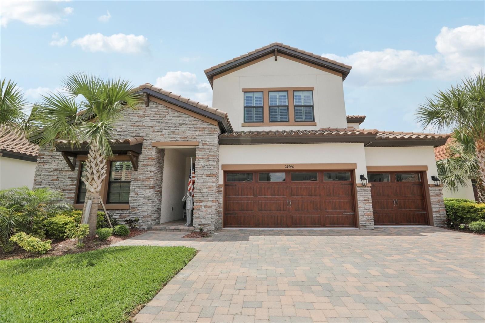 PRICE REDUCED!! NO CDD COMMUNITY!! Lots of custom upgrades! Experience elevated living in this stunning 5-bedroom, 4-bath home in the heart of Land O’ Lakes. Boasting over 3,000 sq ft, this thoughtfully designed residence features generous 12-foot ceilings and a spacious 3-car garage. The gourmet island kitchen opens to a bright café area and expansive lanai, perfect for indoor-outdoor living. The backyard features beautiful pavers on the porch, and a pergola with automatic electric shades! The staircase features beautiful wood stairs. Enjoy the oversized bonus room, ideal for work or leisure, and a generous laundry space that adds everyday convenience. The Owner's Suite features a double vanity with room to spare. Exterior lighting that can be customized ($7,000 value) The Community features a large private dock with direct access to a serene spring-fed lake—your personal retreat awaits. Make sure you view the 3D Walkthrough! ALL CHANDELIER'S DO NOT CONVEY.