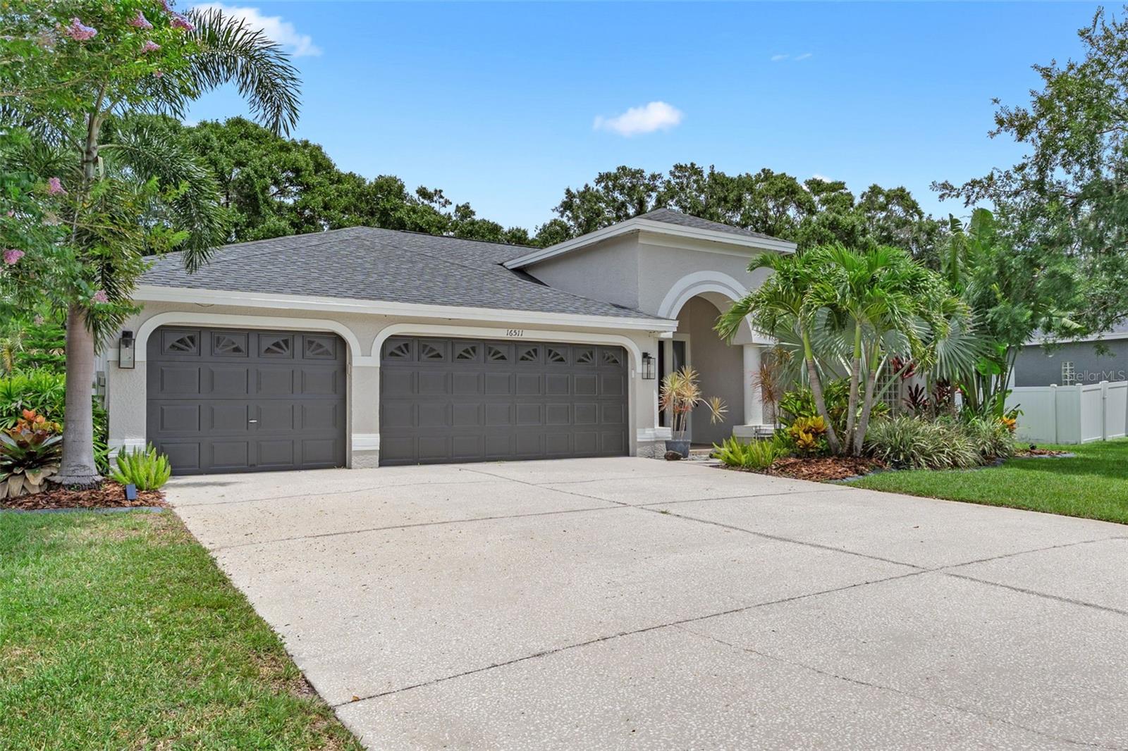 Welcome to resort-style living in the highly sought-after, guard-gated community of The Eagles in Odessa! This beautifully maintained 4-bedroom, 3-bathroom home with a 3-car garage offers a flexible floor plan designed for both comfort and entertaining. As you enter, you’re greeted by a formal dining room and a dedicated office/flex space just off the foyer, with the spacious primary suite privately located at the front of the home. The additional three bedrooms are thoughtfully positioned toward the back for a true 3-way split layout — perfect for multigenerational living or hosting guests. One of the secondary bedrooms even features its own en-suite bathroom, ideal for in-laws or visitors. The heart of the home boasts a light-filled family room with beautiful curved windows that flood the space with natural light. The kitchen offers plenty of counter space, a breakfast bar, and a charming breakfast nook with a window that overlooks the home's expansive bonus room — an enclosed flex space with skylights, large windows, a pool table, dart board, and full bar, offering endless possibilities for entertaining or recreation. The primary suite is a true retreat with a spa-like bathroom including a soaking tub, walk-in shower, dual vanities, a spacious walk-in closet, and three additional linen closets for maximum storage. Step out onto the screened-in patio, complete with a hot tub, covered gazebo, and cozy patio set, all with stunning views of the 13th hole of the golf course. The backyard also features a playground-style swing set included in sale. Upgrades include new flooring and lightning fixtures throughout, kitchen appliances (2023) exterior painted (2024), hot tub on patio (2023) an energy efficient tankless water heater (2020) and a portable air conditioning system for the garage if you'd like to turn one of them into a garage, Roof (2014) and AC (2019). No CDD Fees, Low HOA Fees, No Flood Insurance Required. Located in a 24/7 guard-gated golf course community, residents enjoy access to two championship golf courses, a clubhouse with dining, basketball and tennis courts, a community park, and scenic walking trails. All of this within easy reach of top-rated schools, shopping, dining, and Tampa’s best amenities. Don’t miss your chance to own this one-of-a-kind home in one of Odessa’s most desirable neighborhoods.