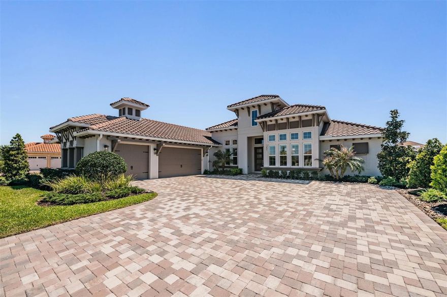 Welcome to an extraordinary 2023 ICI Homes luxury estate in the prestigious Lake Jovita Golf & Country Club community—where refined design, resort-style amenities, and expansive space come together to create one of the most sought-after lifestyles in the Tampa Bay area. Boasting 4 bedrooms, 4.5 bathrooms, 3,435 sq. ft., and a private guest casita, this residence is perfectly positioned on a .66-acre homesite for ultimate privacy and elegance.
Step inside to a breathtaking great room with soaring vaulted ceilings, enhanced by a custom shiplap accent wall and expansive sliding glass doors that seamlessly connect indoor and outdoor living. The chef’s kitchen is a true showpiece, featuring quartz countertops, a stunning floating island, designer blue and grey cabinetry, and a bright breakfast nook with pocket doors. Culinary enthusiasts will appreciate the premium Thermador stainless steel appliances, including a gas range, along with a walk-in pantry with pull-out shelving and a striking wine display.
The owner’s suite offers a private sanctuary with dual walk-in closets and a spa-inspired bath showcasing a soaking tub framed by a picturesque window, dual vanities, a glass-enclosed walk-in shower, and access to a serene private courtyard. Each of the two additional guest suites in the main home features its own en-suite bath, while the detached guest casita (1 bed / 1 bath) provides the perfect retreat for visitors, multigenerational living, or a private office—accessible from the outdoor lanai.
Designed for entertaining and relaxation, the outdoor living space is nothing short of spectacular. Enjoy a covered lanai with summer kitchen, dining area, and an expansive luxury paver pool deck surrounding a heated saltwater pool and spa with sun shelf and fountains, all enclosed by a panoramic screen.
This home is equipped with high-end systems for comfort and efficiency, including a tankless water heater, Culligan water system, whole-home generator, and a Pentair remote-controlled pool system. A 3-car garage and oversized laundry room with extensive storage complete the home’s functional luxury.
Residents of Lake Jovita enjoy access to world-class amenities, including two championship golf courses, a clubhouse, resort-style pool, tennis and pickleball courts, fitness center, scenic walking trails, and dog parks—creating a true country club lifestyle.