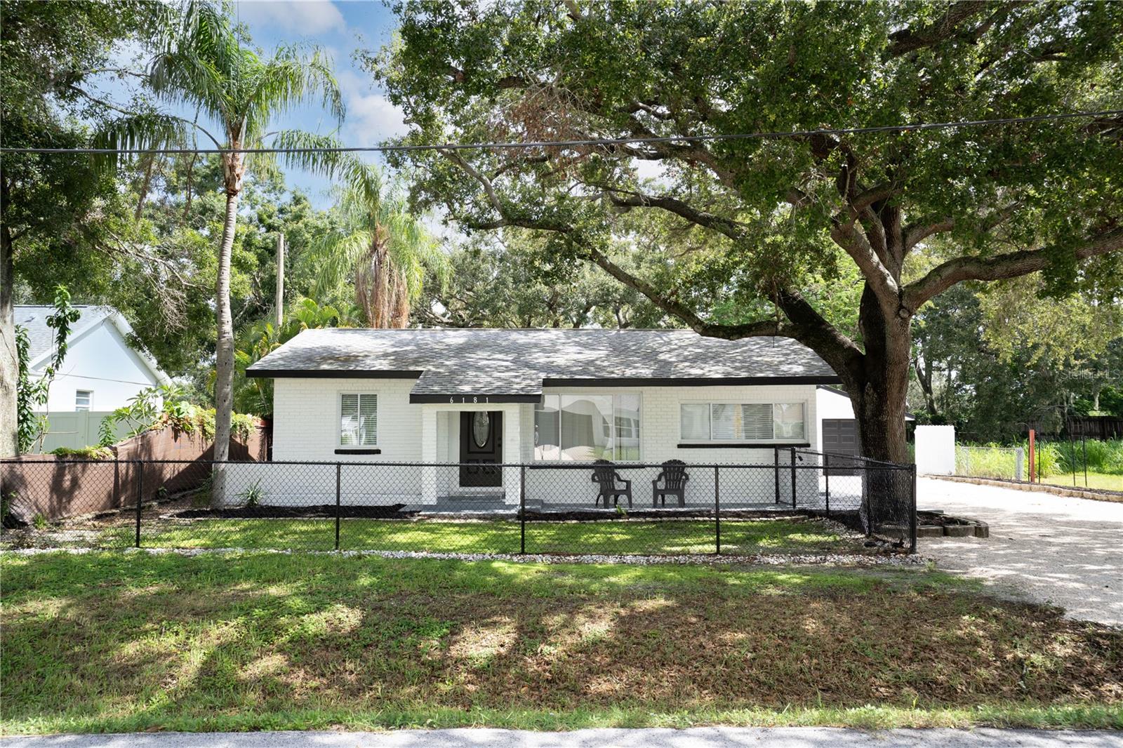 This beautifully updated 3-bedroom, 2-bathroom pool home in Pinellas Park features a detached 2-car garage and is the perfect Florida retreat just in time for summer! Inside, you’ll love the open, light-filled layout with brand new LVP flooring throughout and fresh exterior paint. The kitchen is a showstopper, boasting stainless steel appliances, a beveled mirror glass subway tile backsplash, recessed lighting, a breakfast bar, and a center island—ideal for entertaining. The split floor plan offers added privacy, with a spacious primary suite featuring a custom-tiled walk-in shower and stylish single vanity, while the two guest bedrooms are bright and roomy. The updated guest bath includes modern tile, vanity, and lighting. Step outside to your oversized pool and open patio—perfect for grilling, lounging, or hosting friends and family. Additional perks include inside laundry, newer windows, 2019 roof and electrical, RV/boat parking, and no HOA and no flood zone! Centrally located near parks, downtown St. Pete, beaches, shopping, dining, and entertainment. Don’t miss your chance to make this move-in-ready home yours—schedule your private showing today!