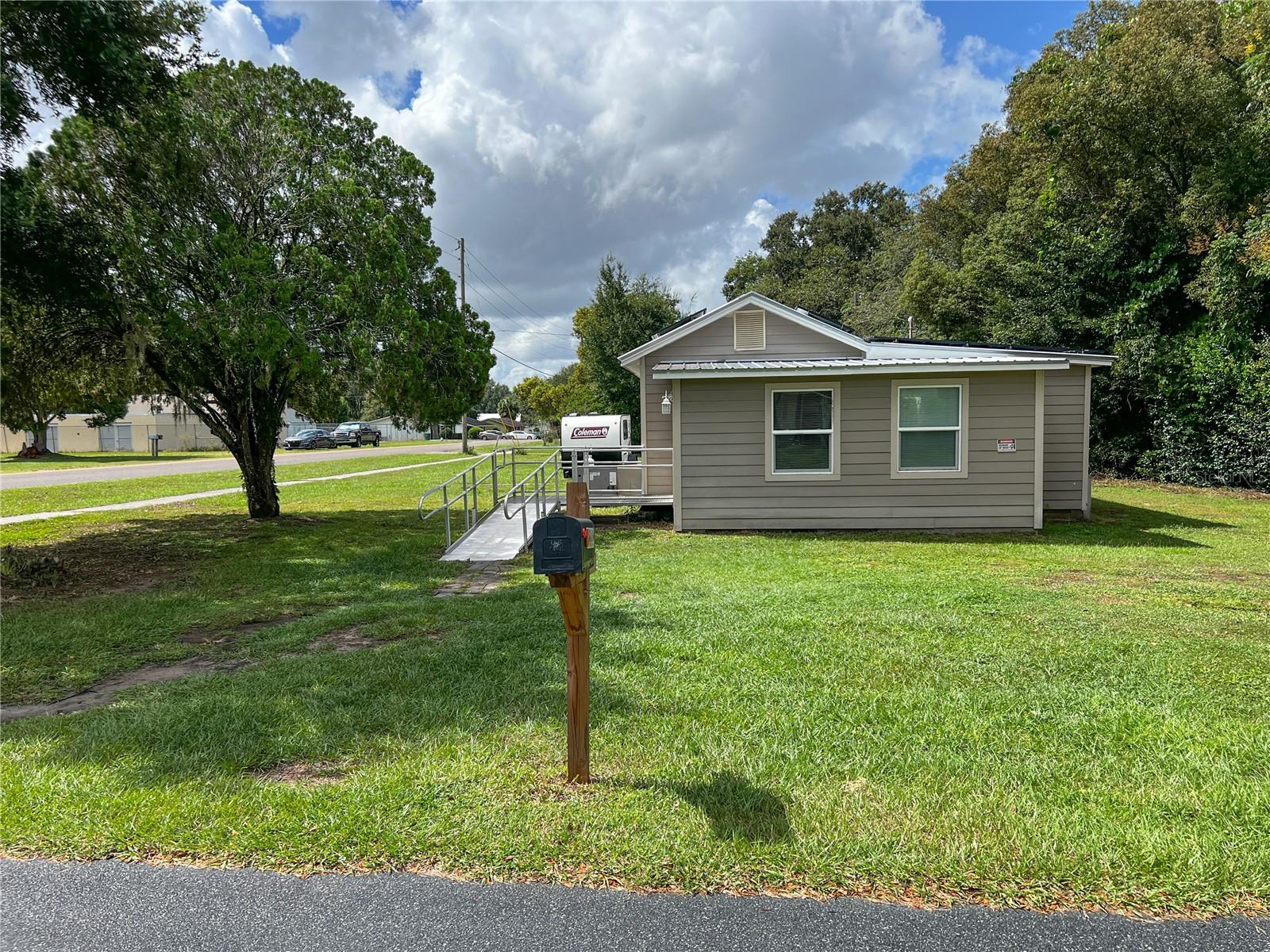 Where Minimal Traditional architecture meets Florida Vernacular design! This charming cottage blends nostalgic character with modern comfort. The Minimal Traditional style reflects the post-war era’s focus on simple, efficient living — compact, practical, and timeless — while Florida Vernacular adds the weather-wise sensibility that makes homes across the Sunshine State so enduring. Together, they create a home that’s sturdy, sensible, and refreshingly uncomplicated. </p><br >Completely renovated prior to the sellers’ 2020 purchase, the home features a new metal roof, new windows, new A/C system, luxury vinyl flooring, new carpet, granite countertops, and new kitchen appliances — bringing modern efficiency to classic design. In 2024, solar energy panels were added, enhancing energy efficiency and reducing utility costs — a smart addition that complements the home’s climate-conscious design. A gently sloped entry ramp leads to the front door, while a wheelchair lift at the rear entry provides convenient access from the kitchen to the covered carport. Wider interior doorways make movement throughout the home smooth and easy. </p><br >Inside, the bright, inviting layout includes a spacious living area and an updated eat-in kitchen with white shaker-style cabinetry, granite countertops, and contemporary fixtures. The two bedrooms share a renovated Jack-and-Jill bath with entries from both the kitchen and the primary bedroom. The bath includes an updated vanity and a walk-in shower (no tub), offering a smart and functional layout for everyday living. </p><br >Additional features include a covered one-car carport, a detached storage shed, and a convenient laundry room with covered access through the carport — keeping household chores dry and easy, rain or shine. The sale also includes a washer/dryer combo, lawnmower, and a water purification system, adding even more everyday value and convenience. The corner lot adds a sense of openness and provides ample outdoor space for gardening, recreation, or future expansion. Durable materials, thoughtful updates, and modern energy efficiency promise years of low-maintenance ownership and peace of mind. </p><br >This charming Zephyrhills home combines space, comfort, and location. Just minutes away, you’ll find Hercules Park, Zephyr Park with its popular Waterplay splash pad, the Zephyrhills Library, Krusen Skate Park, and a variety of other recreational amenities. Schools, shopping, a theater, a bowling alley, and dining options are all conveniently nearby — making this home as practical as it is appealing. </p><br >Simple, sturdy, and built for the Florida lifestyle — this is Minimal Traditional with Florida Vernacular charm at its best: updated, efficient, and full of character. Don’t miss the chance to make this charming Zephyrhills home your own — schedule your private showing today!