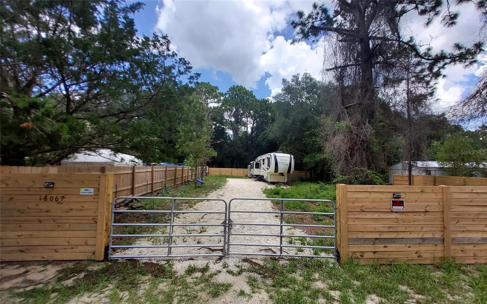 Welcome to your private, cleared, fully fenced-in and gated paradise. The driveway is already in place and compacted. Newly installed wooden fence fully encloses the whole lot along the prior existing metal fence. Brand new 8'x10' metal shed in back of property. The 42' fifth wheel North Point RV can be added for an additional $35,000. Check with county zoning for exemption to live in RV with livestock. Buyer to do due diligence. The road is paved and electricity is easily accessible. There is a very low optional HOA fee for the clubhouse, boat ramp and dock. The boat ramp gives access to the canal to the 185 acre North Lake. The lake is great for fishing, boating and waterskiing.