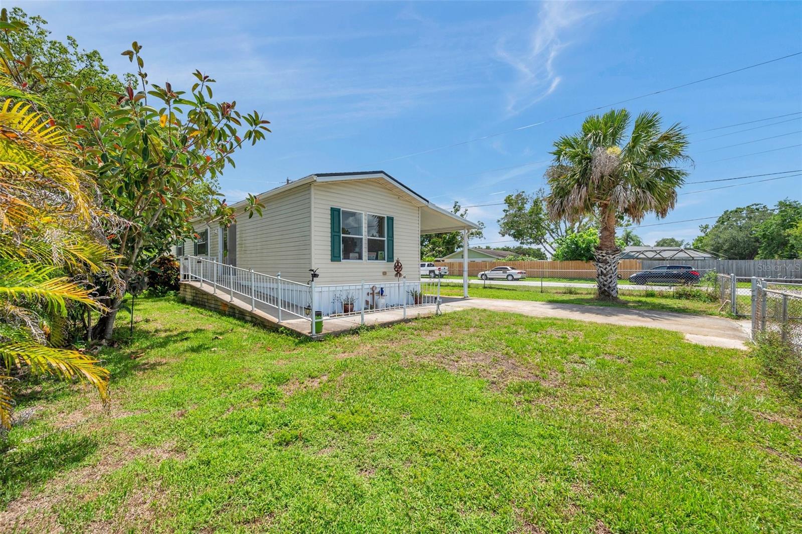 One or more photo(s) has been virtually staged. This charming 2-bedroom, 1-bathroom manufactured home sits on a spacious, oversized corner lot and offers the perfect blend of comfort, convenience, and affordability—with no HOA to worry about! Built in 2001, the home has been lovingly maintained and includes several key upgrades, including a new roof, recently replaced water heater, dishwasher, and washer, plus a 6-year-old AC system for peace of mind.
The functional layout features a sunny Florida room with upgraded storm windows and its own AC, a dedicated indoor laundry room, and an open-concept kitchen, dining, and living area. The living room is cozy but flows seamlessly into the kitchen, making the most of the square footage. The kitchen boasts plenty of cabinet and counter space, perfect for everyday cooking.
Step outside and enjoy the fully fenced yard with irrigation system, ideal for pets, gardening, or weekend projects. The property also includes a powered shed, perfect for storage or hobbies. The corner lot offers great curb appeal, extra parking space, and added privacy.
With no HOA or lot rent, this is a rare opportunity for affordable homeownership in a central Pinellas County location. Whether you're a first-time buyer, downsizing, or looking for a low-maintenance winter retreat—this home is full of potential!