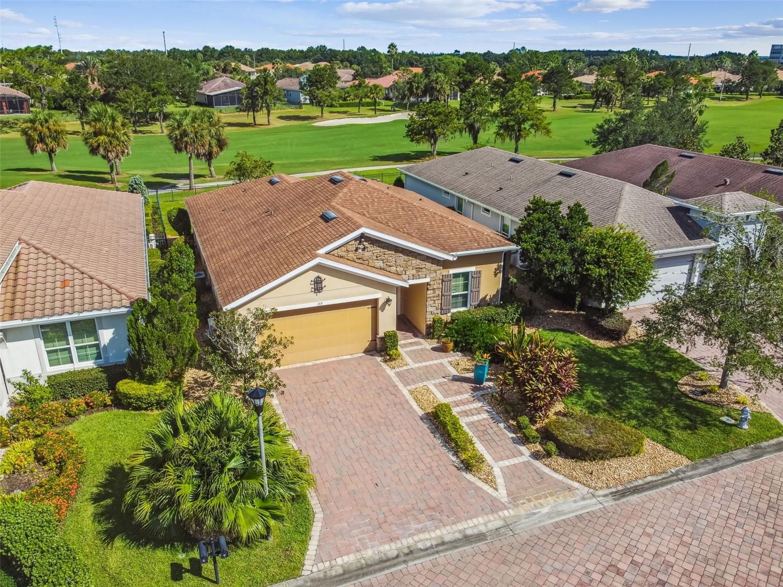 Location, Location, Location! This stunning builder’s custom Cabella Model offers the perfect combination of luxury, comfort, and convenience. Ideally situated just a short distance from the main gate and a quick walk to the Village Center with its amenities, restaurants, and events, this home truly has it all. Enjoy expansive golf course views from this 2-bedroom, 2-bath home with a den/study and a climate-controlled workshop/hobby room. Designed as a builder’s model, this residence boasts numerous custom upgrades and has been meticulously cared for—LIVED IN ONLY FOUR YEARS! Step through the stone façade and leaded glass front door into a bright, open-concept living area that seamlessly flows to the screened lanai and the serene golf course beyond. The chef’s kitchen features Quartz counters, an eat-at bar, walk-in pantry, and abundant cabinetry, while the dining area offers beautiful views of the lanai and fairway. The spacious primary suite includes an en-suite bath with Quartz counters, dual sinks, a walk-in shower with seat, and an oversized walk-in closet. The guest bedroom and guest bath with walk-in shower, are thoughtfully positioned on the opposite side for privacy. The den/study is enhanced with custom built-in cabinetry and shelving. Outdoor living is at its finest with a screened lanai, a large pavered patio, and a custom outdoor fireplace—perfect for entertaining. Additional highlights include: CDD Debt Paid Off. Custom landscaping & pavered walkway. Tray ceilings & crown molding. Whole-house water filtration system with UV light. Extra closet shelving. New bedroom carpets (2021). Air-conditioned shop/craft room with storage. This home combines elegance, functionality, and upgrades in a premier location—don’t miss this opportunity! All this in one of the top 55+ communities in America. Solivita offers residents access to state of the art amenities and work out facilities, dance and aerobics studios, a business center, 14 heated swimming pools, 2 heated spas, tennis courts, pickleball courts, shuffleboard, bocce ball, billiards room, art gallery, 3 restaurants and 2 championship 18-hole golf courses, driving range and putting course. Every day offers something new to explore and enjoy! This home also features easy access to nearby shops, dining, and health care, offering the perfect balance of privacy and lifestyle. Don't miss out on the opportunity to have a first class lifestyle.