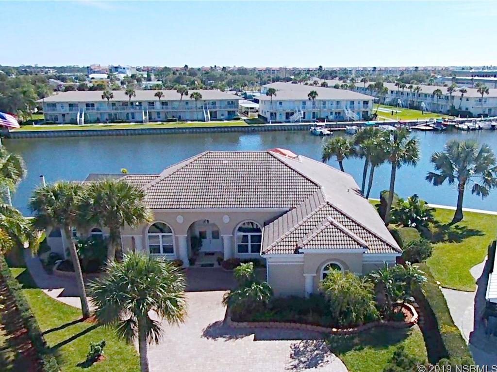 Boaters Dream Home! With over 140 feet of water frontage, this personal marina offers 2 private deep water slips, floating concrete dock, Concrete pilings, 1 large open lift, tile roofed boat house with lift and smaller floating docks for guest boat parking. No expense was spared as the owners re-crafted this home from top to bottom, inside and out in 2018. Better than brand new, this stunning 3/3 pool home is situated on one of the points in the nautical neighborhood of Venezia and therefore showcases views of the deep-water canal from nearly room. Featuring a comfortable and functional floorplan the tray ceilings glow with warm ambient lighting and tile floors throughout lead from room to room with grace and elegance. The gourmet kitchen gleams with custom cabinets, granite countertops and more breathtaking views of the waterway. Other features include a custom built in entertainment center, wet bar, and cozy breakfast nook which also overlooks the pool and canal. Just outside, triple sliding glass doors from the bright and warm living room, you can indulge in a relaxing outdoor oasis complete with a large sparkling pool featuring calming fountains a covered living area and exquisite panoramic views of the canal and yacht inspired marina. ;Water: City
