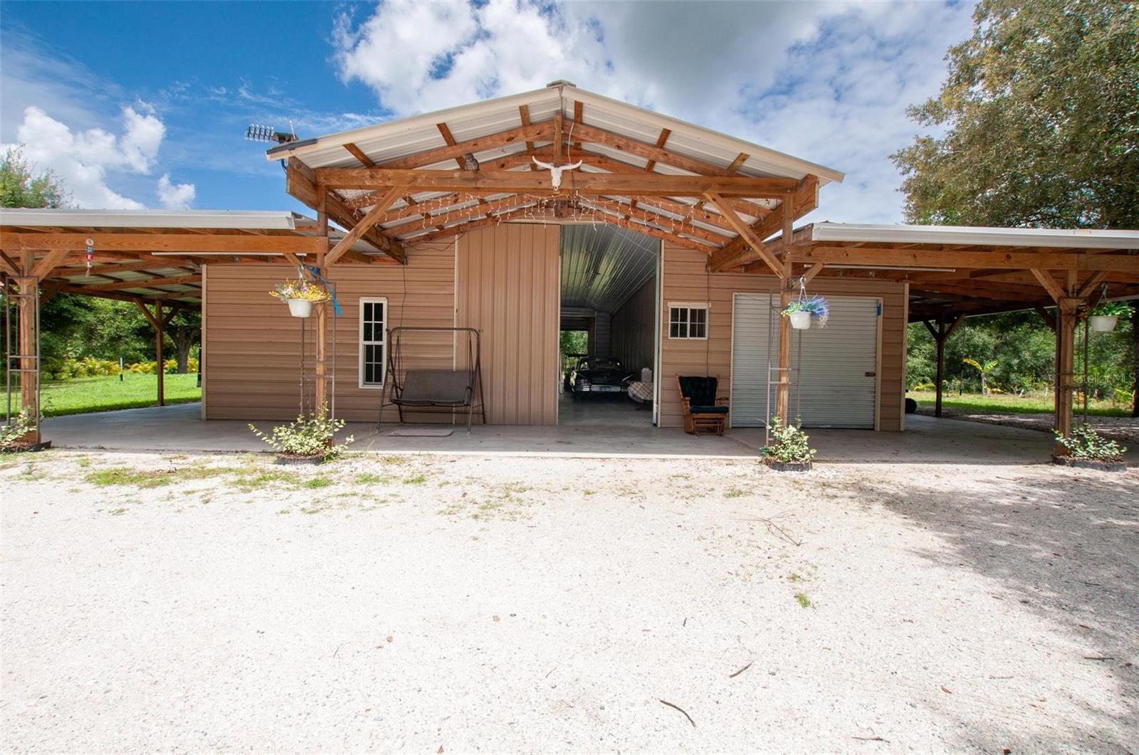 Modern Barndominium on Nearly 4.5 Acres – Built in 2022!
Welcome to this stunning barndominium-style home, built in 2022 and perfectly situated on 2.997 acres with an additional 1.326-acre parcel included! Offering the best of rural charm and modern convenience, this unique property boasts 2,310 sq. ft. of space with hurricane-impact windows, a 2022 roof, and two energy-efficient mini-split units providing both air conditioning and heat. Inside, you’ll find 810 sq. ft. of finished living quarters, an inside laundry room, and an additional 680 sq. ft. area already set up for a bathroom, shower, and living space—ideal for a guest suite or expansion. The entire building features a 10’ wraparound lean-to, offering shade and additional covered space. This home is built for versatility with two RV hookups (30 & 50 amp), a trailer setup with two slide-outs for guests, and a propane gas stove, Lenox propane furnace, washer, dryer, and dishwasher all included. Enjoy the Florida lifestyle outdoors with six different fruit trees, water treatment system on well, and plenty of room to grow.
Don’t miss this rare opportunity to own a turn-key, multi-use property with space, upgrades, and flexibility for all your needs!