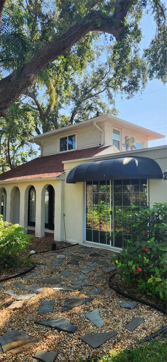 Set on an expansive and beautifully landscaped nearly quarter acre corner lot, this 3 bedroom, 2 bath Spanish-style home with a den offers rare flexibility in the heart of the historic Manatee River district. Surrounded by majestic live oaks and royal palms, the property provides ample room to expand. Whether you envision adding onto the home, installing a pool, or creating your dream outdoor living space. With no HOA restrictions, your options are wide open. Inside, you'll find original hardwood floors, hurricane-rated windows, fresh paint, remodeled baths. Work from home and need a separate office space? You will love the upstairs den. You will also find thoughtfully designed outdoor spaces including a whimsical cedar shake shed, outdoor shower, and multiple seating areas. Just a short walk from the riverfront and close to downtown Bradenton, the Riverwalk, Anna Maria Island beaches, Robinson Preserve, and more. No flooding or storm damage from the storms in 2024. A rare find offering both character and possibility in a truly special neighborhood.
