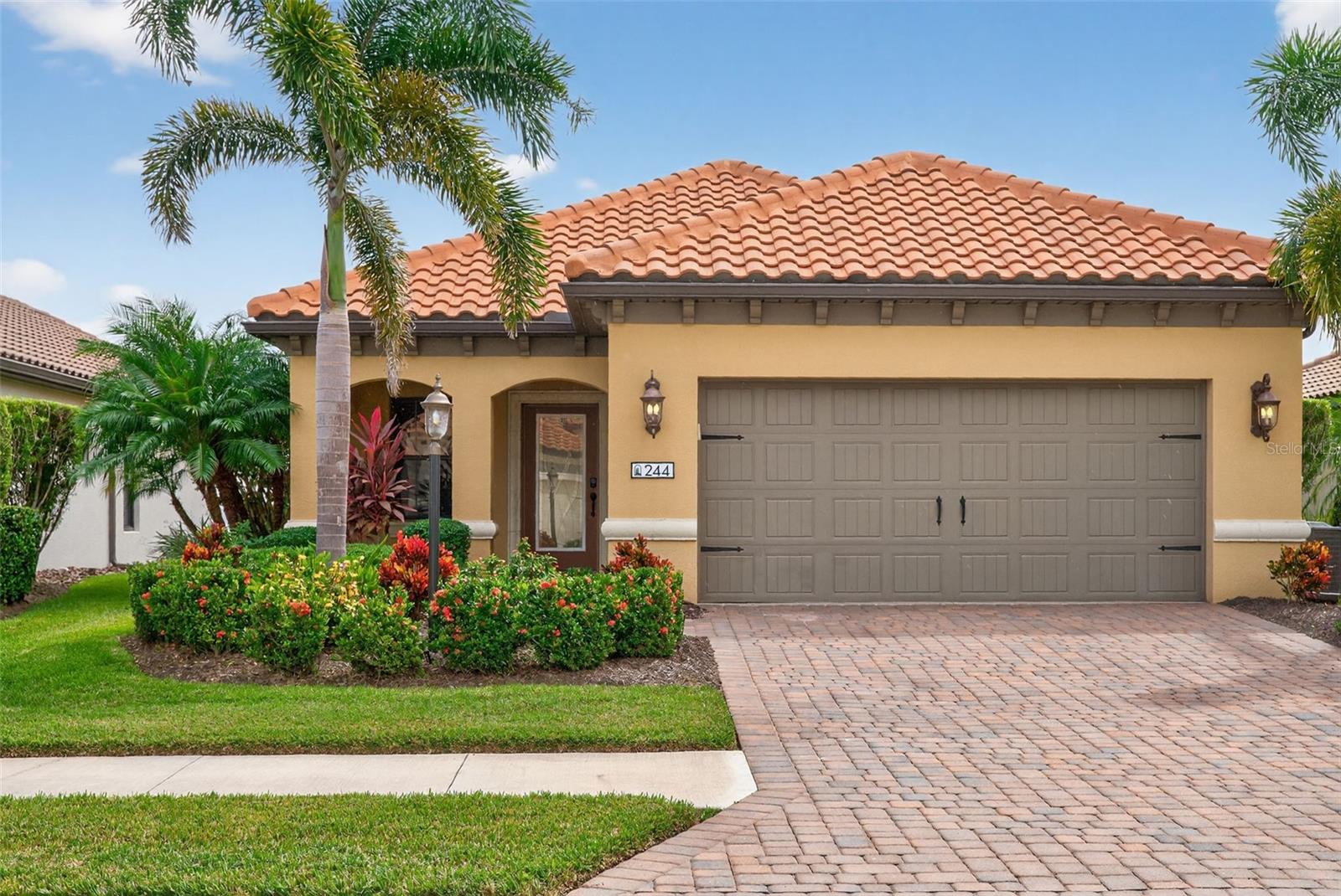 Step into the home that set the standard for Milano. This former model features the premium upgrades and lakefront setting that once welcomed prospective buyers, now ready for you to call home.
An arched front porch and glass entry door open to a spacious foyer with immediate sightlines to the lake through triple pocket sliders. The open floor plan features a great room with coffered ceilings, wood detailing, and plank tile flooring that flows throughout the main living areas.
The kitchen includes white wood cabinetry with crown molding and under-cabinet lighting, tile backsplash, stainless appliances, center island, a large walk-in pantry, and breakfast bar. The dining area features a shiplap accent wall. A den with French glass doors provides flexible space for an office or study.
The primary suite offers dual walk-in closets, a shiplap accent wall, and an ensuite with a glass-enclosed walk-in shower. Two additional bedrooms have walk-in closets and share a full bathroom. The utility room includes cabinetry and storage.
The screened lanai overlooks the lake and includes a heated saltwater pool (heater installed 2021). Milano offers resort-style amenities: clubhouse, community pool and spa, fire pit, bocce and pickleball courts, and dog park. Low HOA fees, no CDD, and close to beaches, I-75, downtown Venice, and top-rated schools.