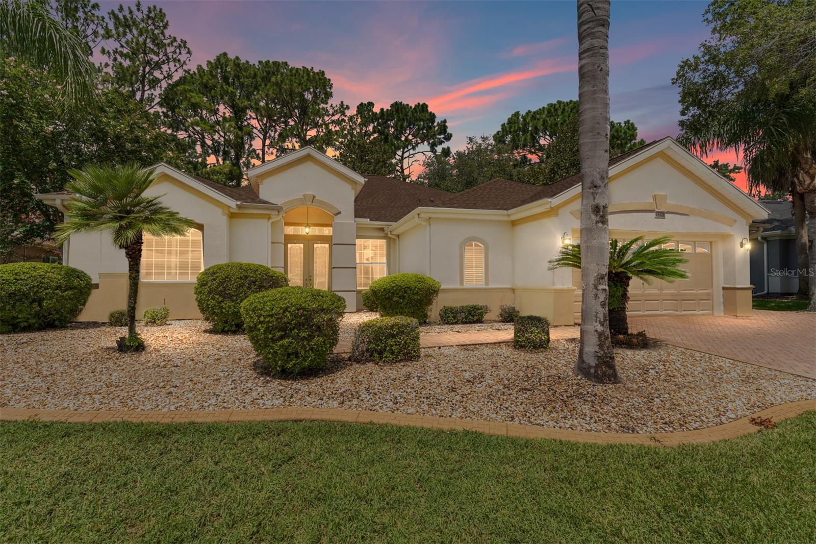 Step into this pristine 2-bedroom, (plus Den/Office/Art Studio/Craft Room) 2 1/2-bathroom home and be captivated by the golf course views of the 7th Green of the Heritage Golf Course in Del Webb's Spruce Creek Golf & Country Club community, located in Summerfield; an hour North of Orlando, 20 minutes South of Ocala and 4 miles North of The Villages, Florida. Entering through the 9' double entry front doors with beveled glass inserts, you will find yourself inside a beautiful home with wonderful appointments. The Formal Living and Dining Rooms are very large and spacious and beyond them you will find an open floor plan with a HUGE kitchen with 42" cabinets, cabinet pull-outs, Corian countertops and tile backsplash; as well as a breakfast nook and 15' x 14' Family Room with gorgeous views of nature in between the home and the golf course. This home has a split bedroom plan and an inside laundry room. You will not find a bigger garage than this one, which includes a workshop, parking for 2 cars and a tandem golf cart garage, serviced with a side door to the outside. The home's Roof was replaced in 2018, Generator installed in 2018 and HVAC System in 2017. There are plantation shutters throughout EXCEPT on the back of the home, which would only block the beautiful views outside. There is also crown moldings through-out and 5' basebords. The home is in exceptional condition. Offering a 1 Year Broward Factory Home Warranty. Discover your forever home - schedule a tour today to experience this home first hand.